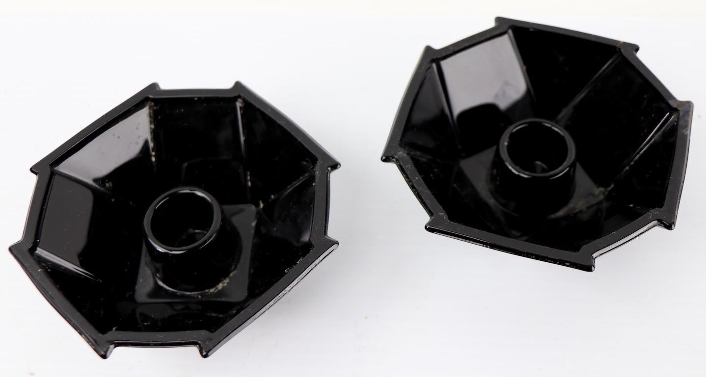 Pair of ebony glass octagonal geometric candlesticks, designed by George Sakier. For the Fostoria Glass Company. Both are free of damage, clean and ready to use. Art Deco, Machine Age style, classic American elegant glassware.