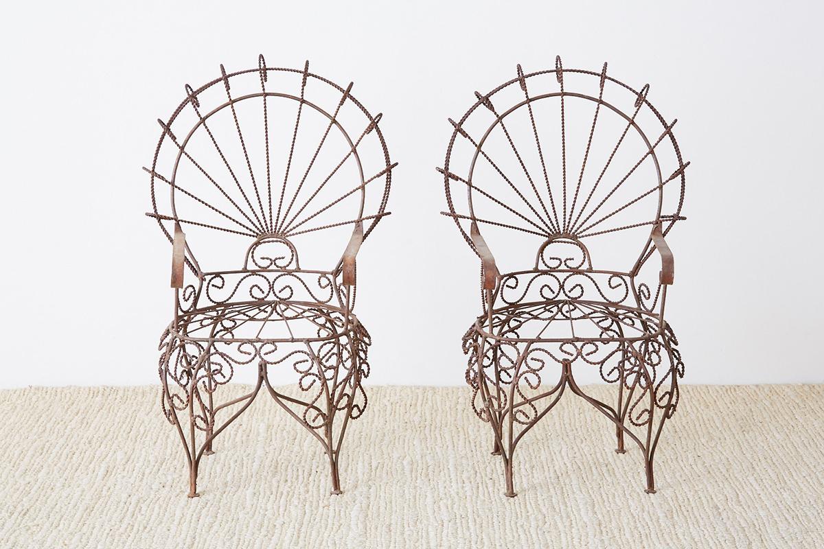 Phenomenal pair of miniature wrought iron peacock chairs designed by John Salterini. This diminutive set of doll size chairs were made as sales samples featuring intricate iron work. Impressive attention to detail with excellent joinery and iconic