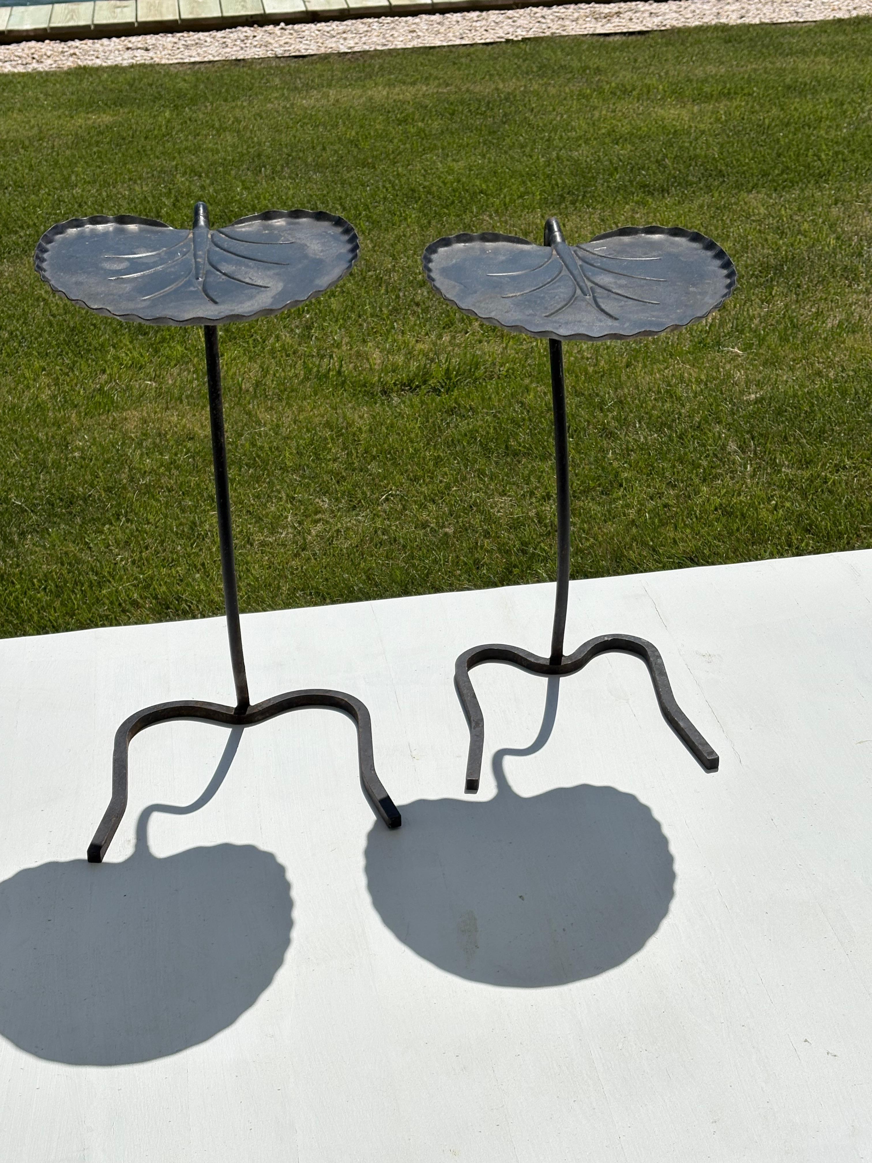 This iconic pair of wrought iron Lilly Pads were designed in the 1960s by John Salterini . The tables are very versatile and can be used as side tables,accent tables or in the garden as sculpture. Very charming , sturdy and  high quality make these