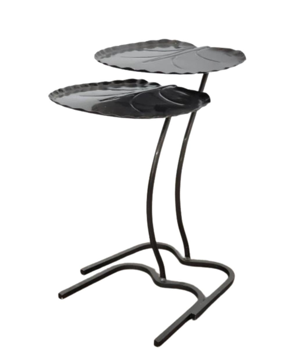 Add a touch of sculptural elegance to your space with this whimsical pair of black iron nesting tables, styled after the iconic Lotus Leaf design by Maurizio Tempestini for Salterini. Emulating the midcentury modern ethos, each table features a
