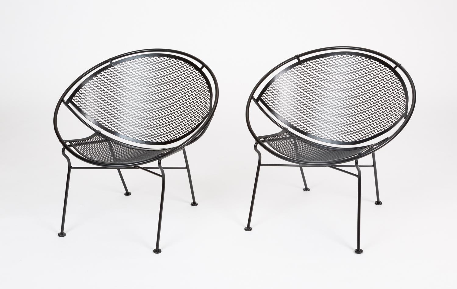 Two “Radar” wrought iron patio lounge chairs designed by Maurizio Tempestini for John Salterini. Each chair has a bisected hoop construction with a delicate grid of wrought iron forming the body. Four angled legs with flat disc feet support the