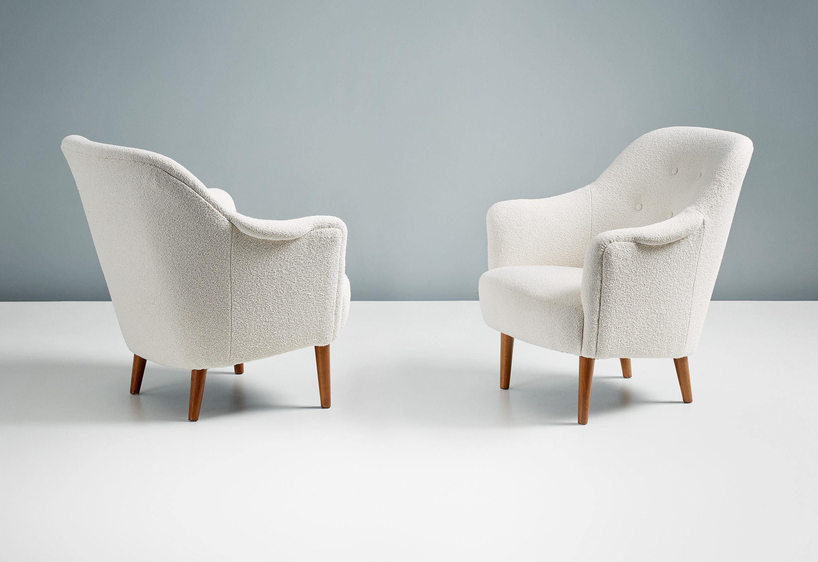 A pair of armchairs designed by Carl Malmsten in 1956 and produced by AB Record in Sweden. This pair have been reupholstered in Chase Erwin 'Embrace', a luxurious boucle fabric. The legs are stained beech.

  