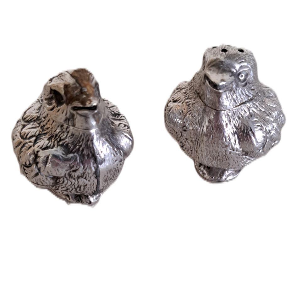 A fine pair of silver  salt and pepperette chicks modelled  by Sampson Mordan.
The pepper is dispensed from the top of the chicks head, the salt is designed for the salt to poor out through the beak. They weigh approx 15g each and are about 4cm or 1