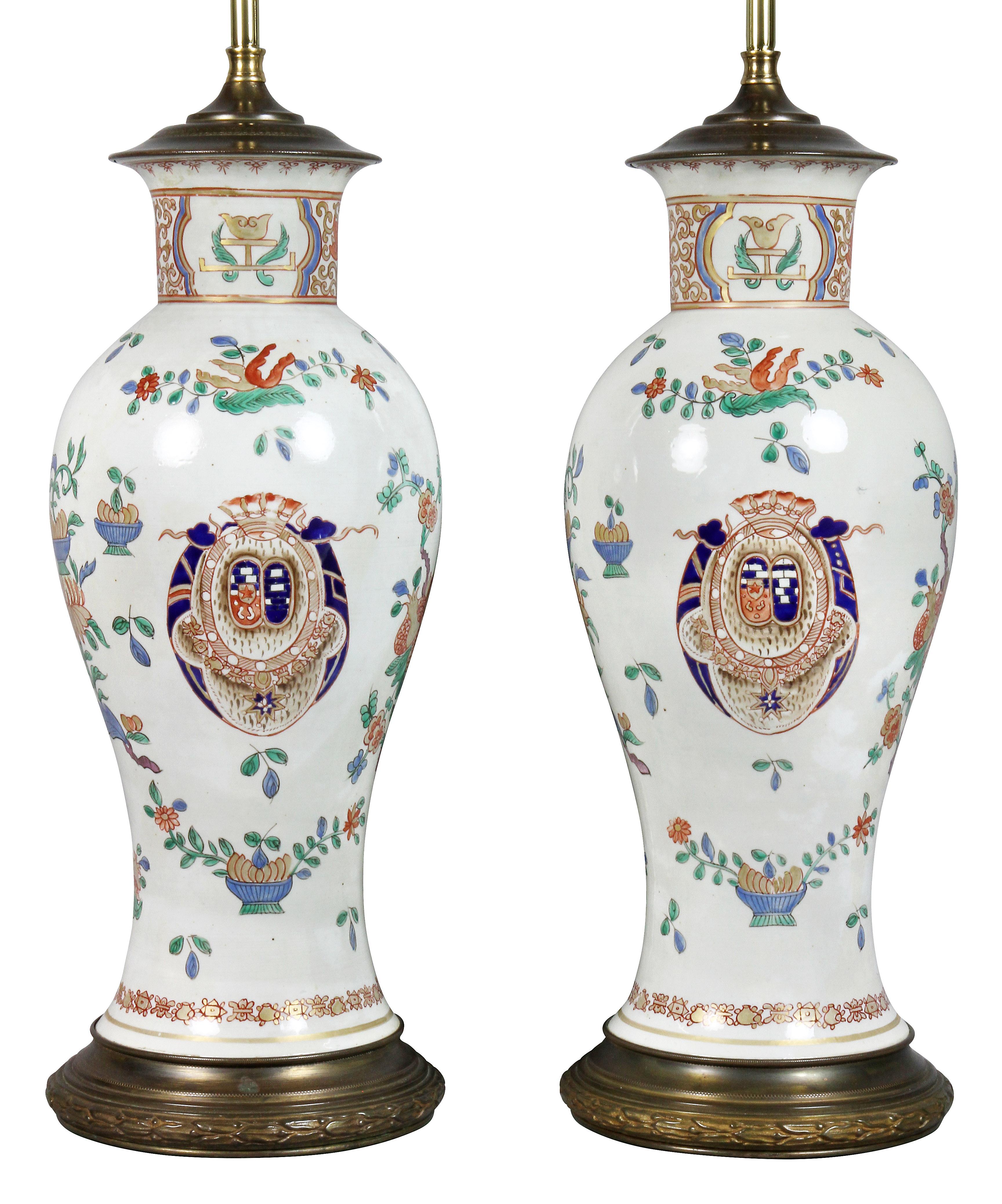 Baluster form decorated with a central crest with overall reds, greens and blues.