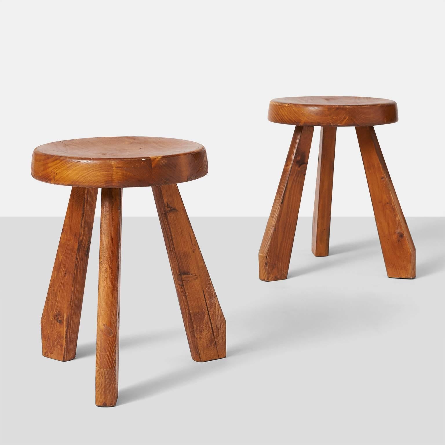 A pair of pine stools by Charlotte Perriand with a thick, round seat. The wood has a beautiful natural aged patina. The 'Sandoz' stool was originally designed, circa 1955, and was used in Perriand’s own chalet in Me´ribel. In 1962 she used the model