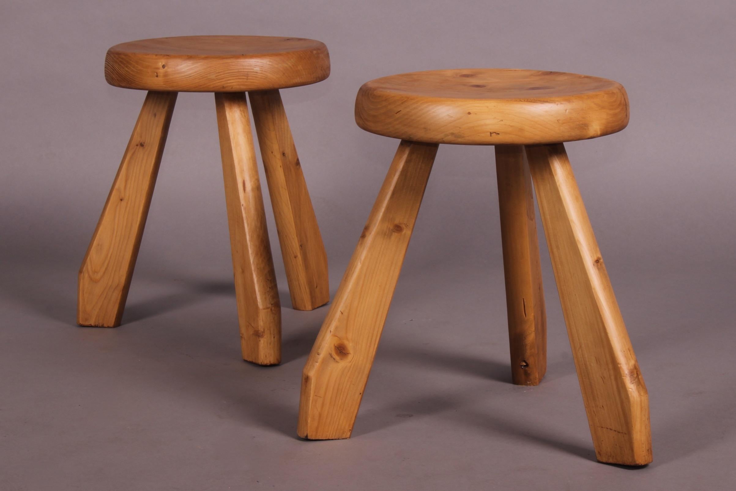 A pair of pine stools by Charlotte Perriand with a thick, round seat. The wood has a beautiful natural aged patina. The 'Sandoz' stool was originally designed, circa 1955, and was used in Perriand’s own chalet in Me´ribel. In 1962 she used the model