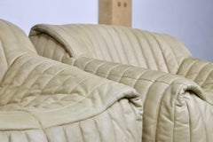 Pair of Sandra lounge chairs in cream leather by Anne Hieronimus for Cinna, 1970