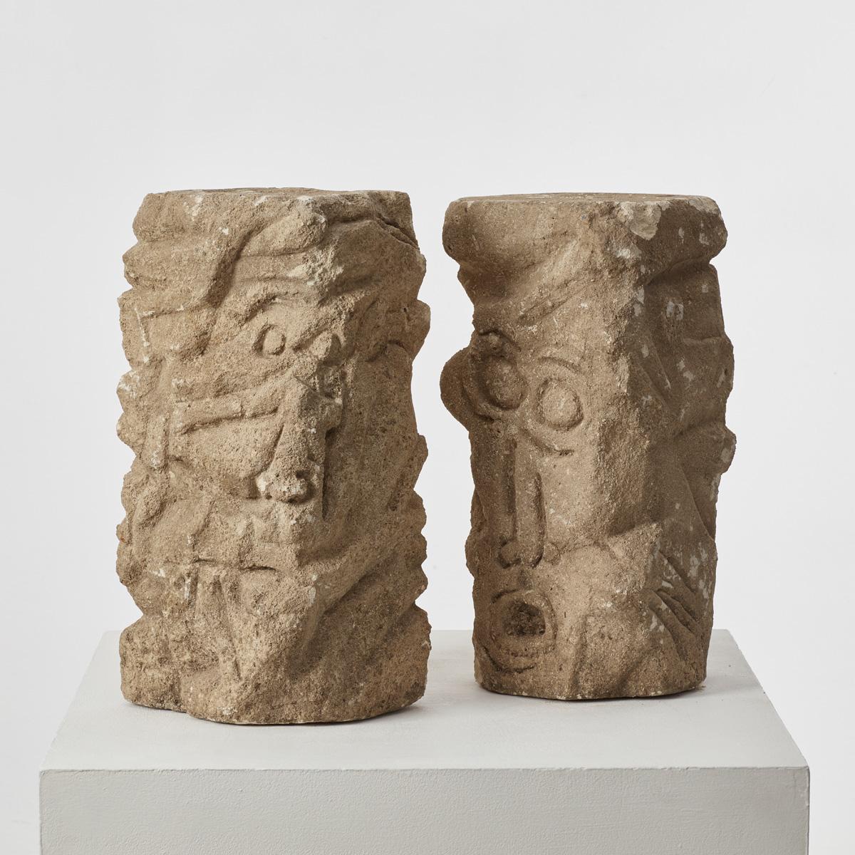 There is something both ancient and modern about this pair of sandstone sculpture. The grimacing faces that leer from the rock could be fractured elements of an archaic column, or Romanesque architectural sculpture, or works of twentieth-century