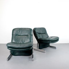 Pair of "Sandwich" armchairs with chrome-plated metal frames and green leather