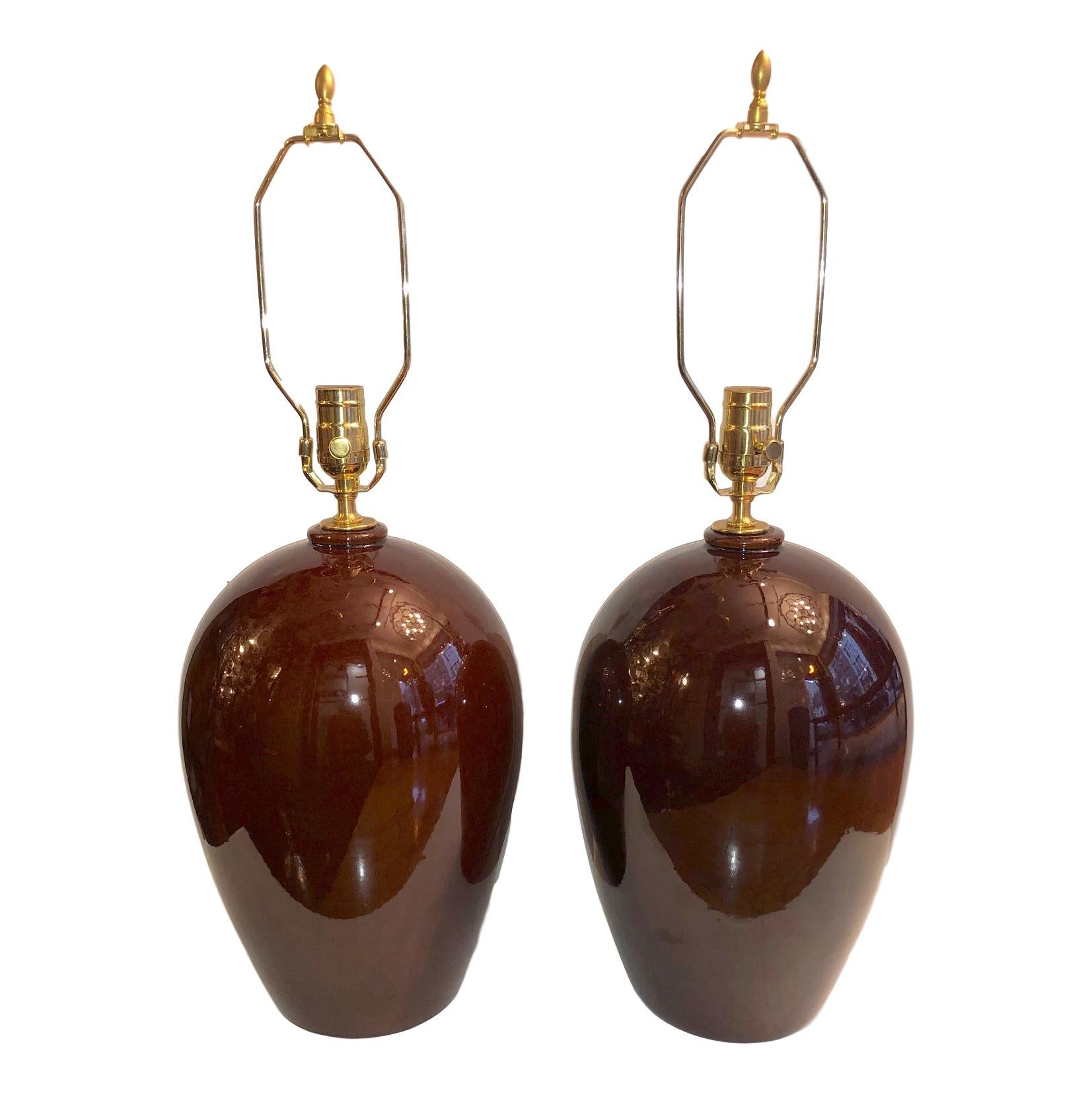 A pair of circa 1940's French ox blood color table lamps.

Measurements:
Height of body: 14.5