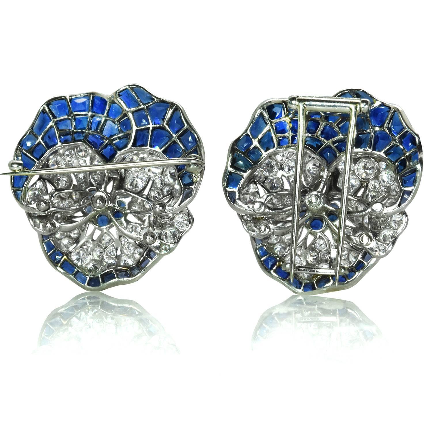  A pair of iconic pansy pins by Oscar Heyman & Brothers. The pins feature approximately 8.00 carats of sapphires and 2.60 carats of diamonds each, which are set in platinum. Both pins are accompanied by authentication letters from Oscar Heyman &