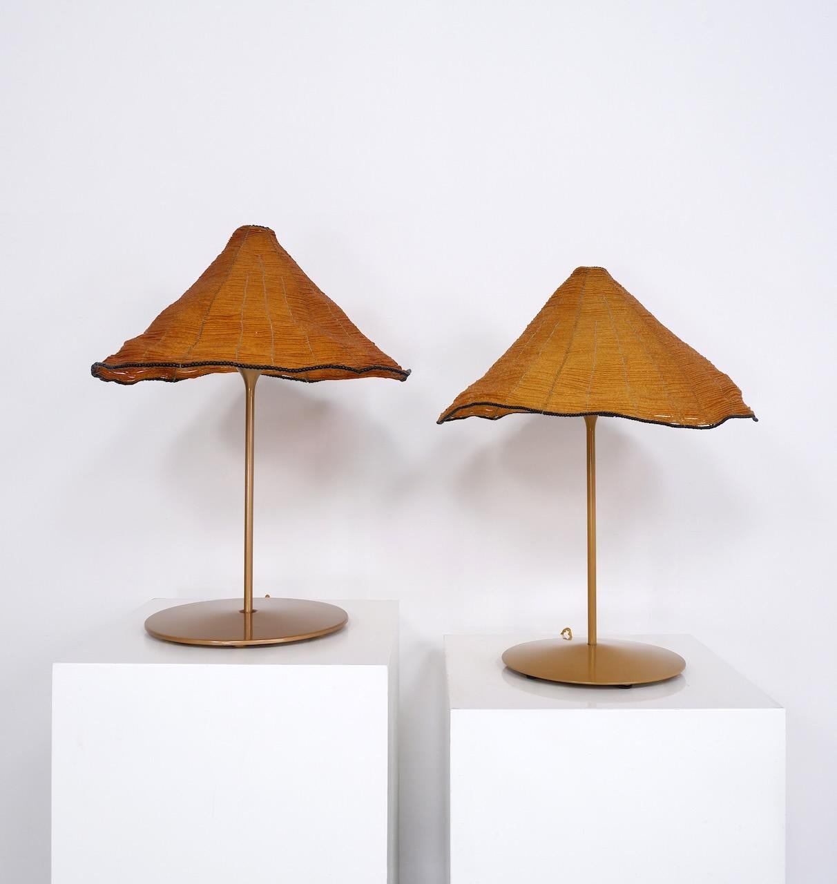 Pair of 'Sarasar T' tables lamps designed by Roberto Pamio and Renato Toso and produced by Leucos in the 1980s to 1990's. 

The shades of the Sarasar T lamps are formed from 1000's of small amber glass beads threaded on to a wire frame, rimmed with