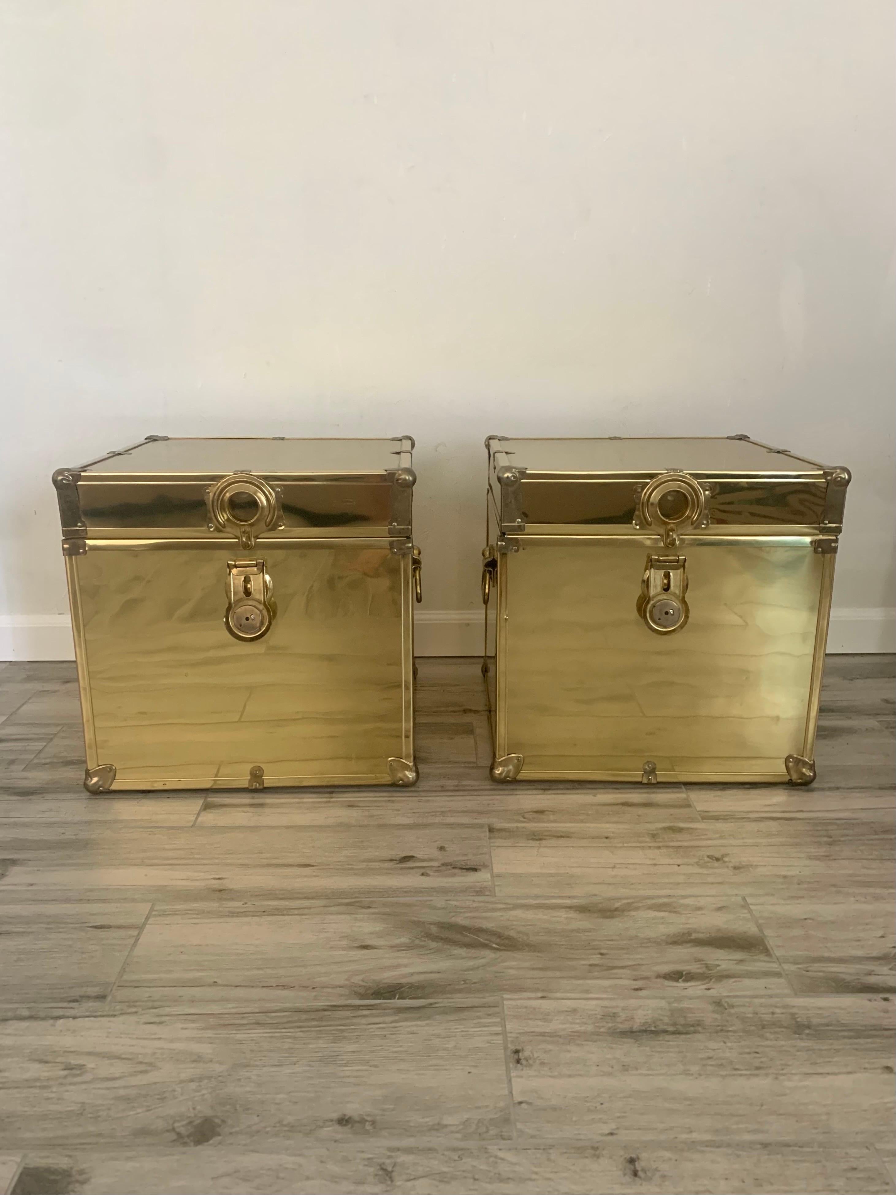 A pair of decorative brass trunks. In the style of Sarreid. Mid 20th century production. Latches to lock them if desired. Would make great end tables or decorative storage in any room. 

Both boxes are lidded with a hinge and have two handles on