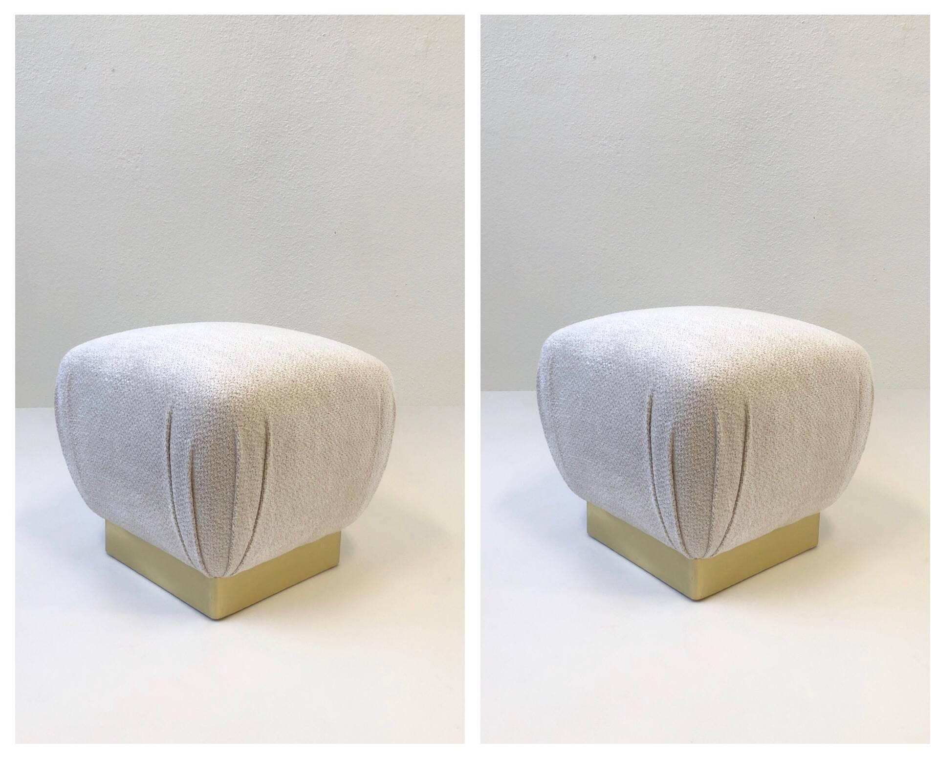 A glamorous pair of 1970s poufs by Marge Carson. The base is wood covered with a satin brass band. Newly recovered with a soft off white with light grey dreads Chanel fabric (see detail photos).

Dimension: 18” high 20” wide 20” deep.