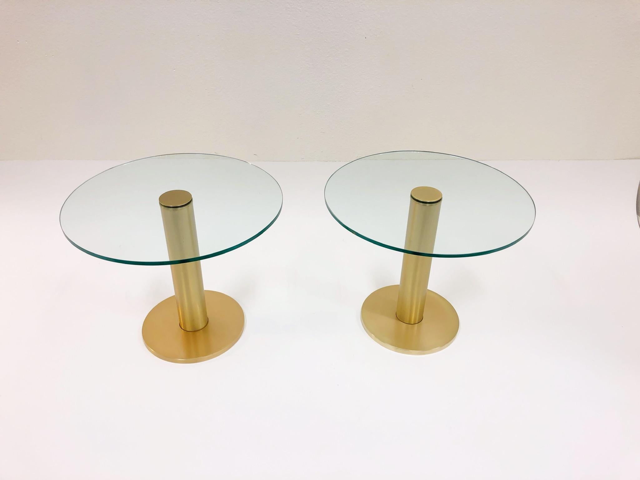 A pair of 1970s satin brass and glass side tables by Pace Collection. New 1/2”thick glass tops. 
Dim: 20” diameter 16.25 high.