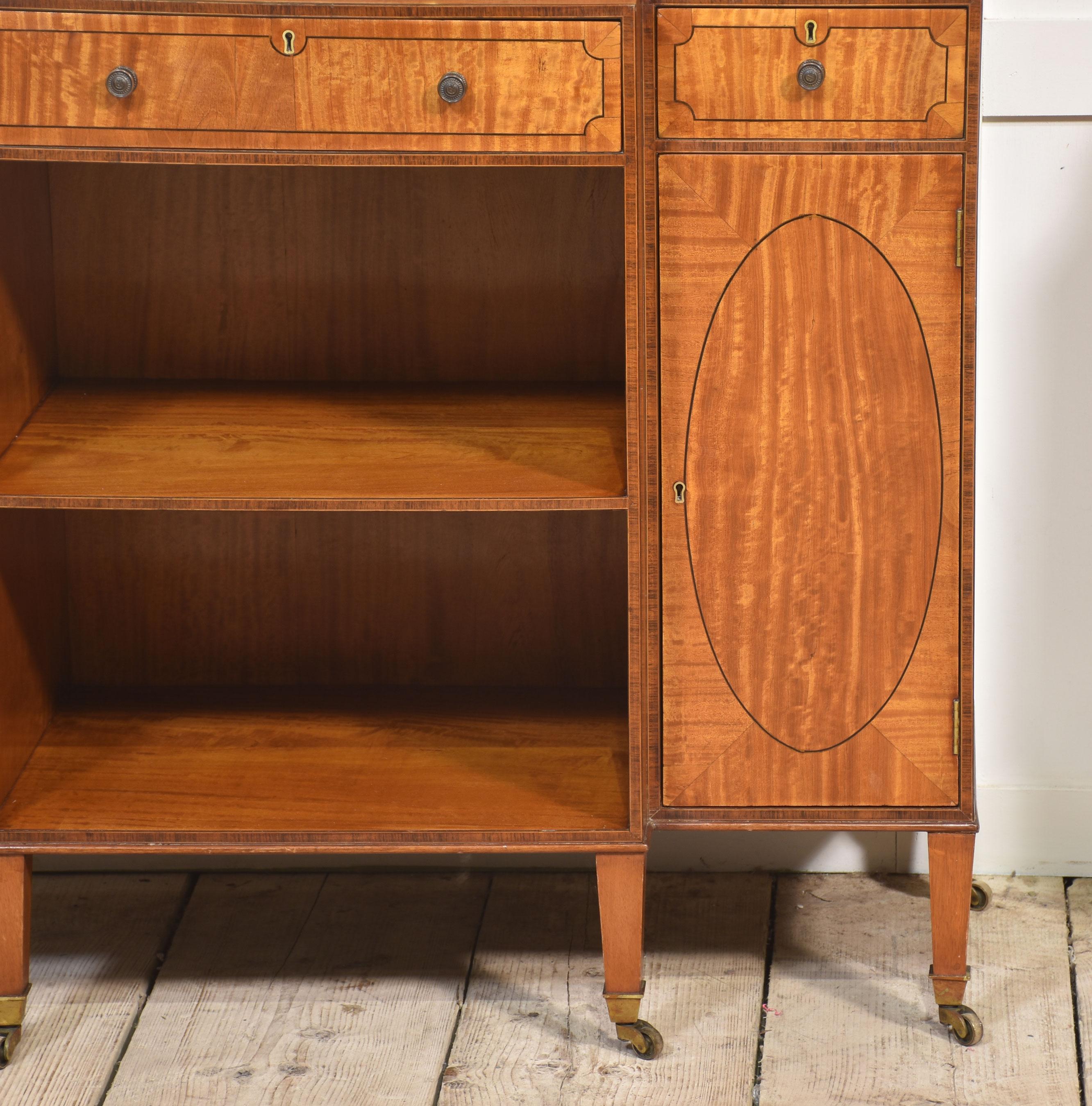 Pair of satinwood crossbanded open breakfront waterfall bookcases of small proportions. In the George III Neoclassical style Each with ebonised and boxwood stringing and line decoration, the superstructure comprised of a waved galleried top above