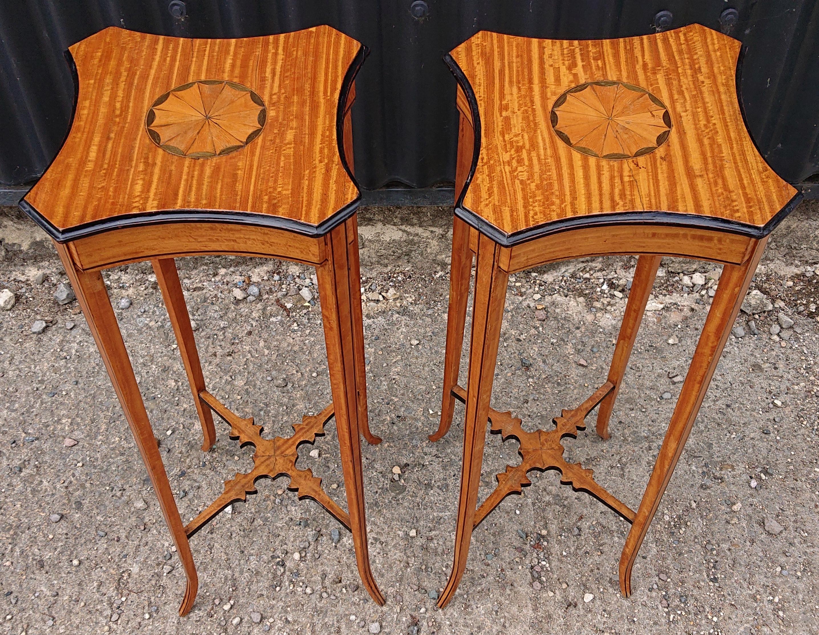 Fine pair of Georgian revival wine tables. This pair of tables are made of a particularly interesting cut of satin wood with Harewood / sycamore inlay and ebonized detail. The splay legs make them more stable than their elegant design would