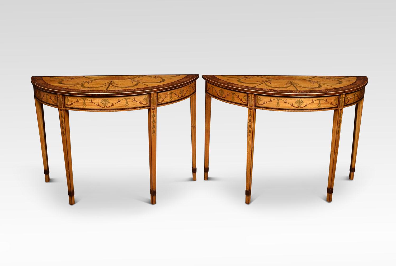 Pair of satinwood inlaid neoclassical style demilune console tables, the half moon shaped tops having floral marquetry inlay with ribbon and swag and fan detail. To the frieze again with ribbon and swag inlaid panels. Supported on square tapering