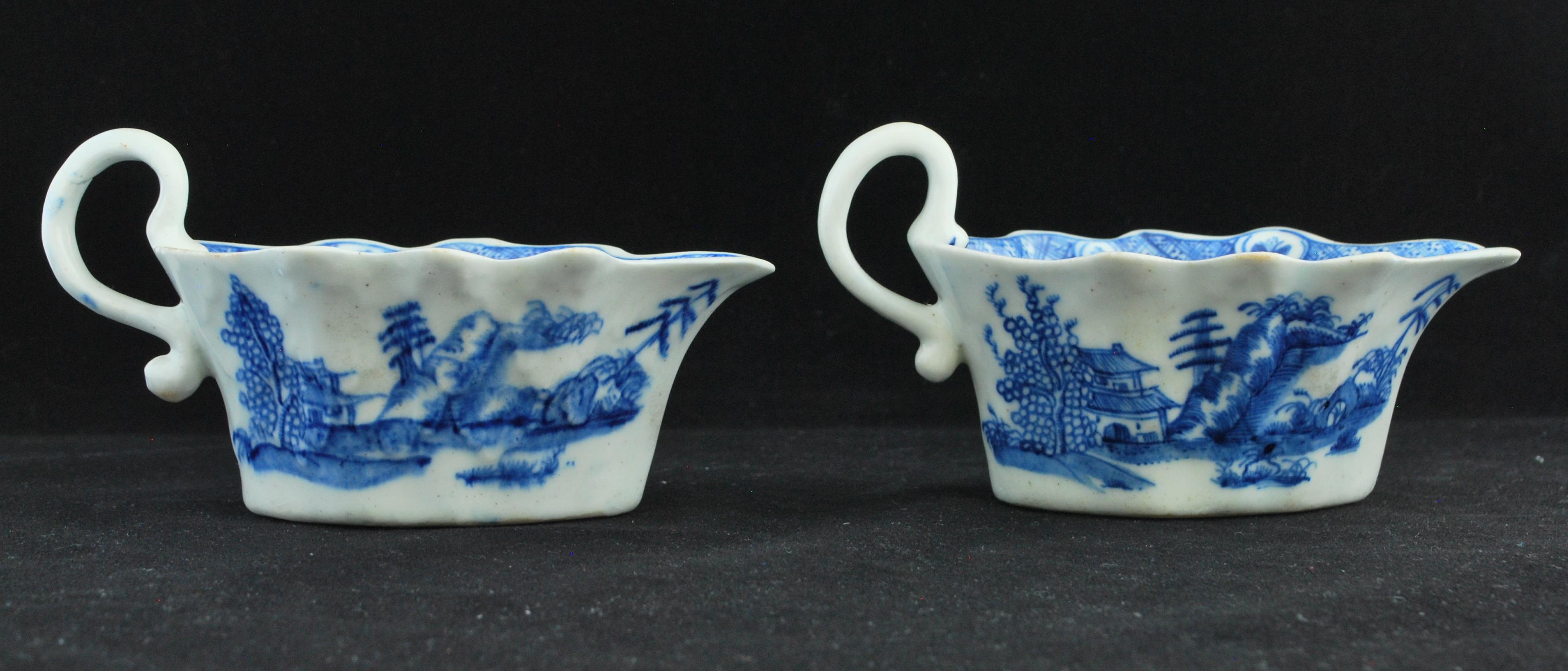Pair of Sauceboats, circa 1752-1755: 

Of flat hexagonal form with waved top and scroll handle, painted after the Chinese in blue with the ‘desirable residence pattern’ of a building amidst rocks and trees; the interiors with hatched borders.