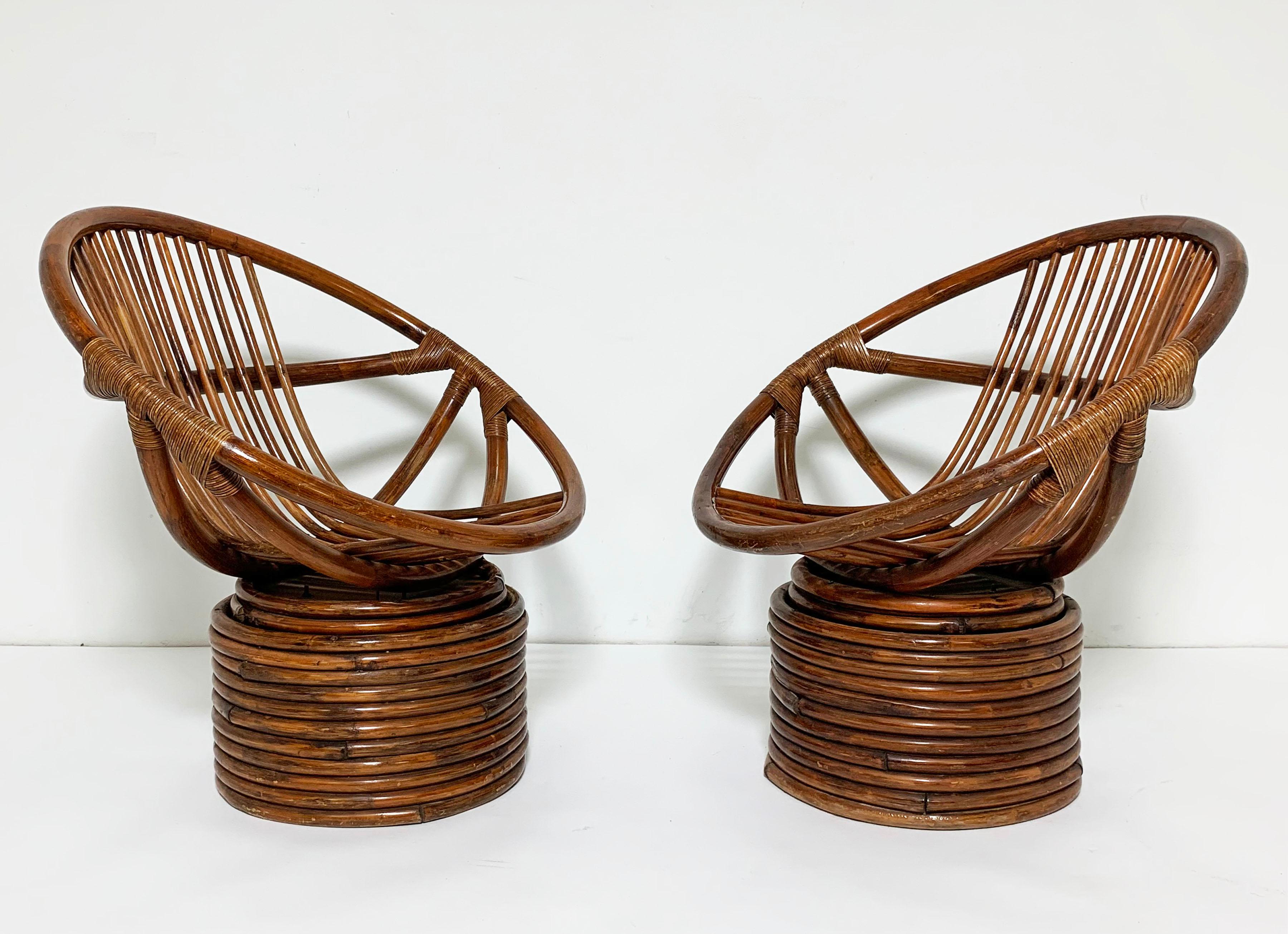 A pair of saucer-form swivel lounges in rattan, circa 1960s attributed to Sun Tropic Products of Vernon, California. These vintage chairs have always resided safely indoors. They’re extremely comfortable, even without seat cushions that might