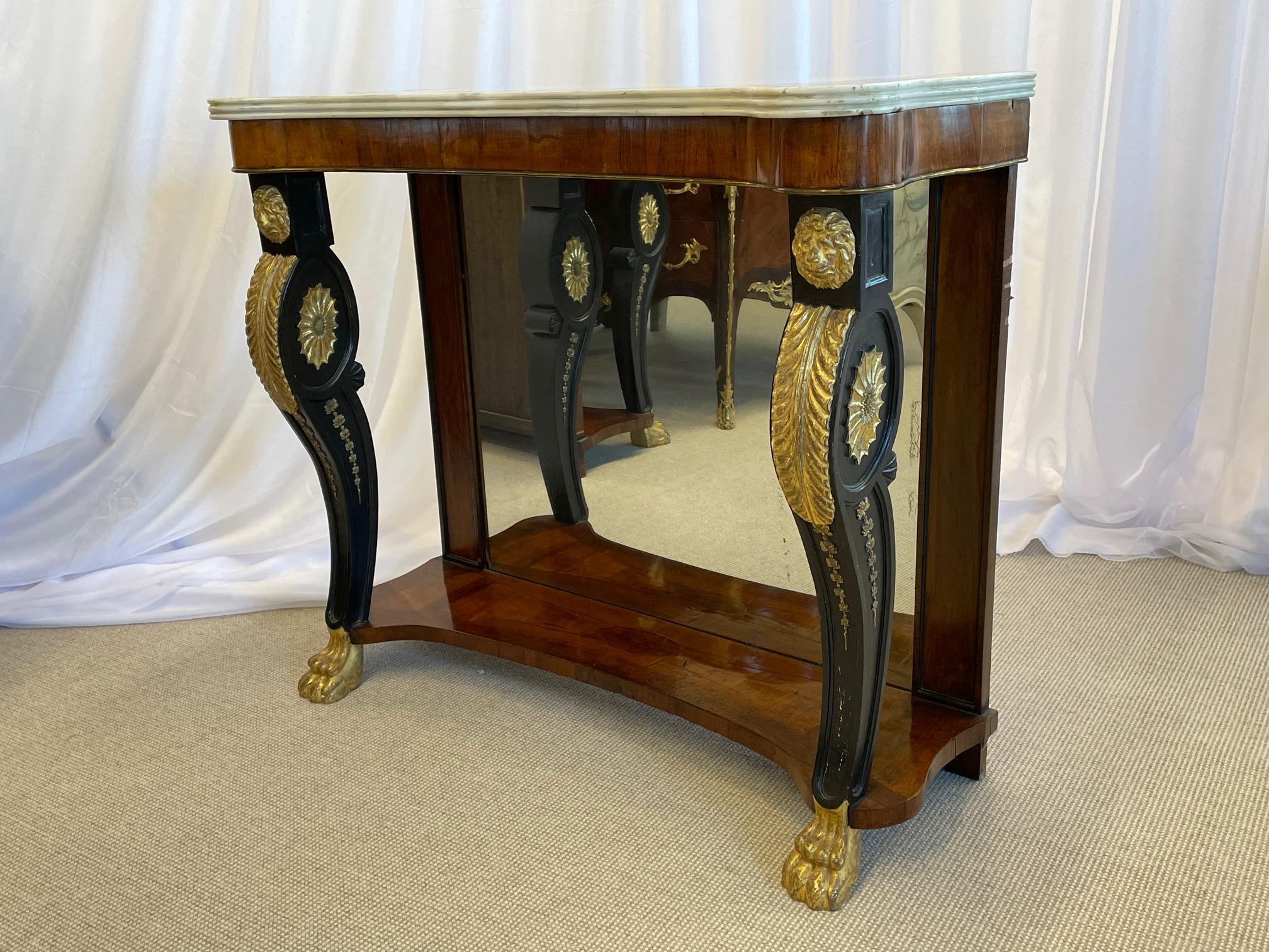 A pair of one of a kind Scagliola inlaid Carrara marble-top consoles the tops possibly by Pietto Bossi. The fine ebonized and water gild legs having claw feet with carved gilt decorative work leading to a lions face the over all leg in a serpentine