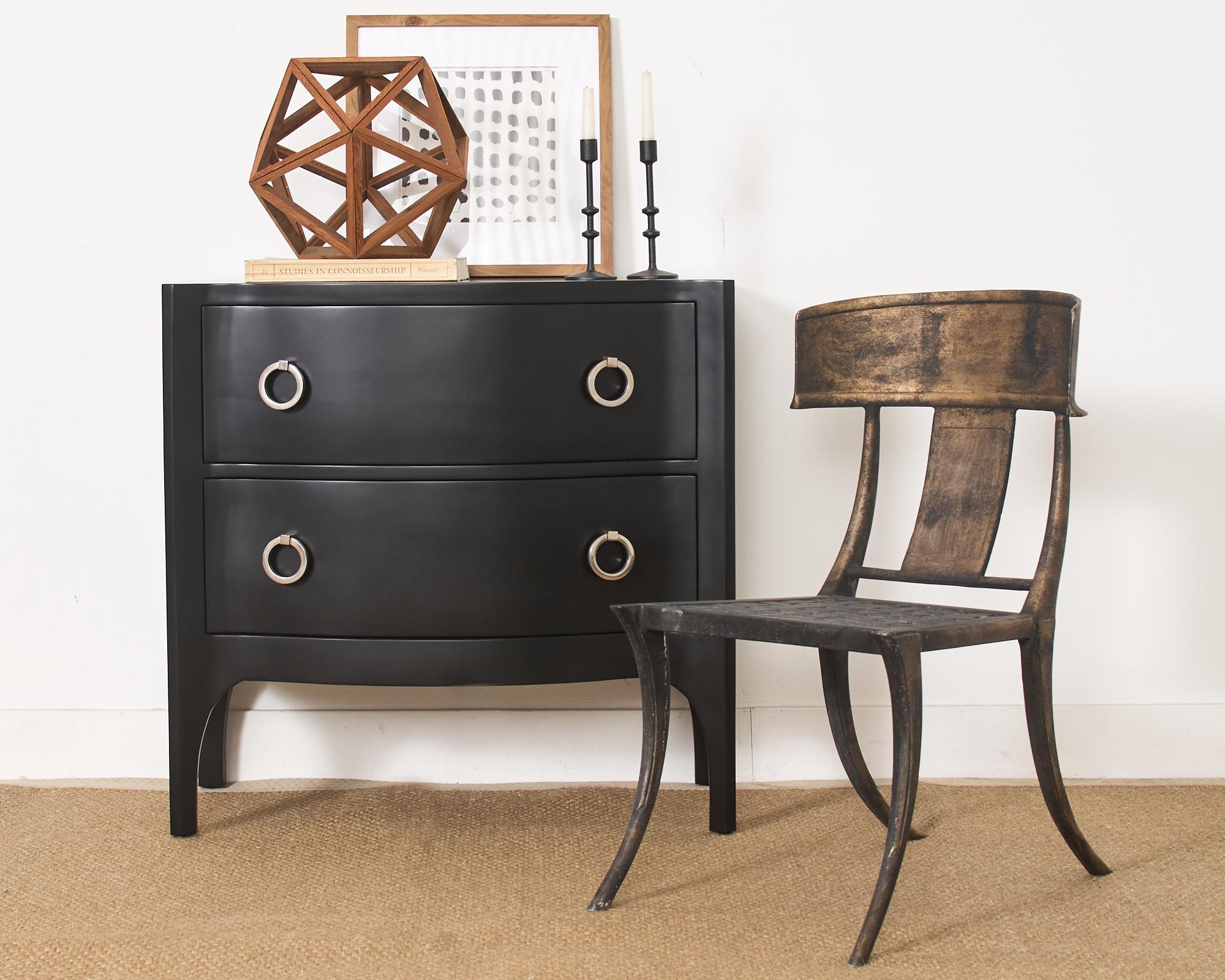 Dramatic pair of Trapu commodes or chests of drawers by Scala Luxury Los Angeles, CA. The chests feature a matte black lacquered finish with a rich mahogany interior that showcases the woodgrains. The commodes have a serpentine or bow front fitted