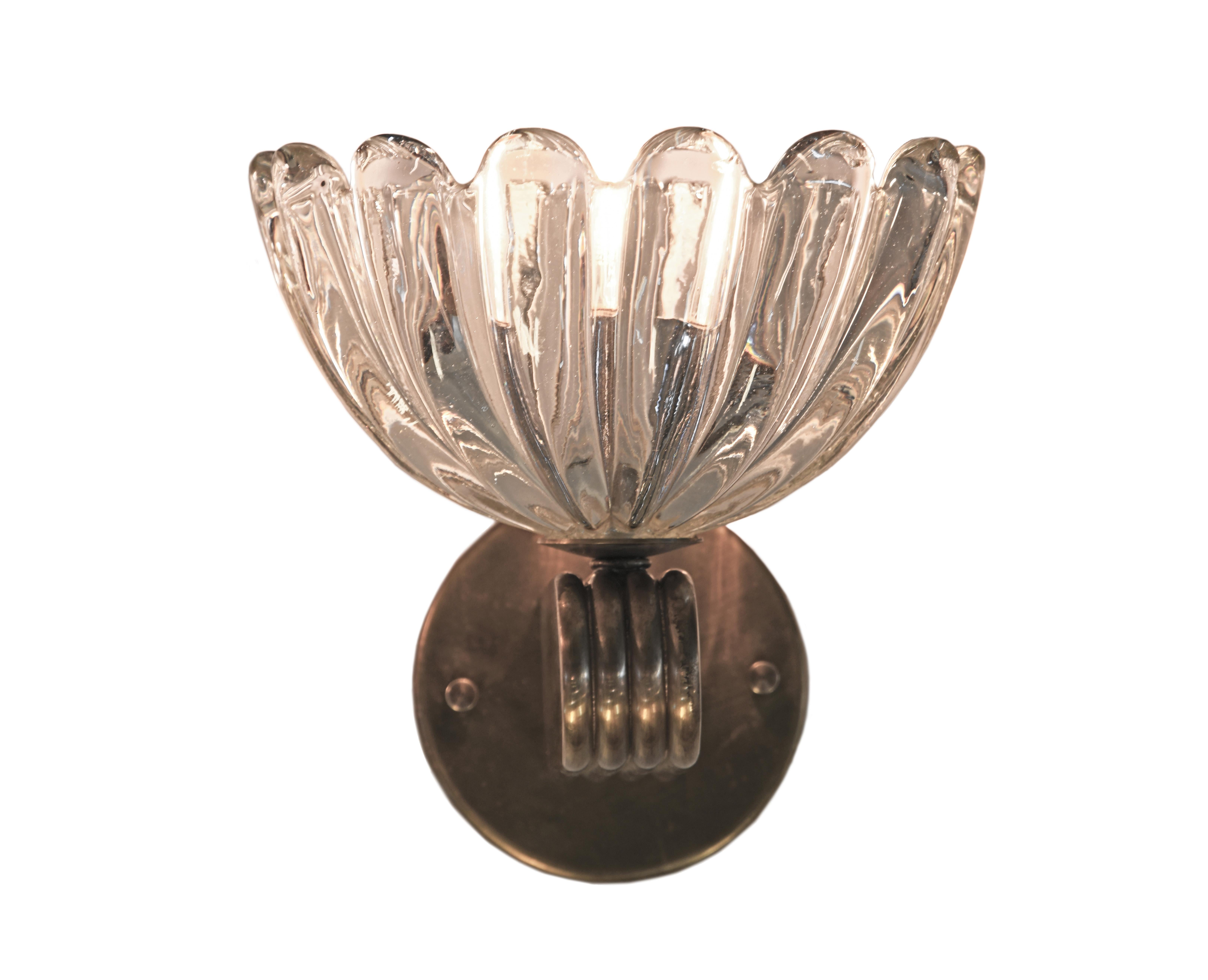 Charming sconces with heavy, hand blown Venetian Fiori ‘flower’ shades in scalloped clear cristale glass and solid antique brass arm and backplate with a distinctive scalloped detail.

Thomas Cooper Studio represents a multilayered, multifaceted