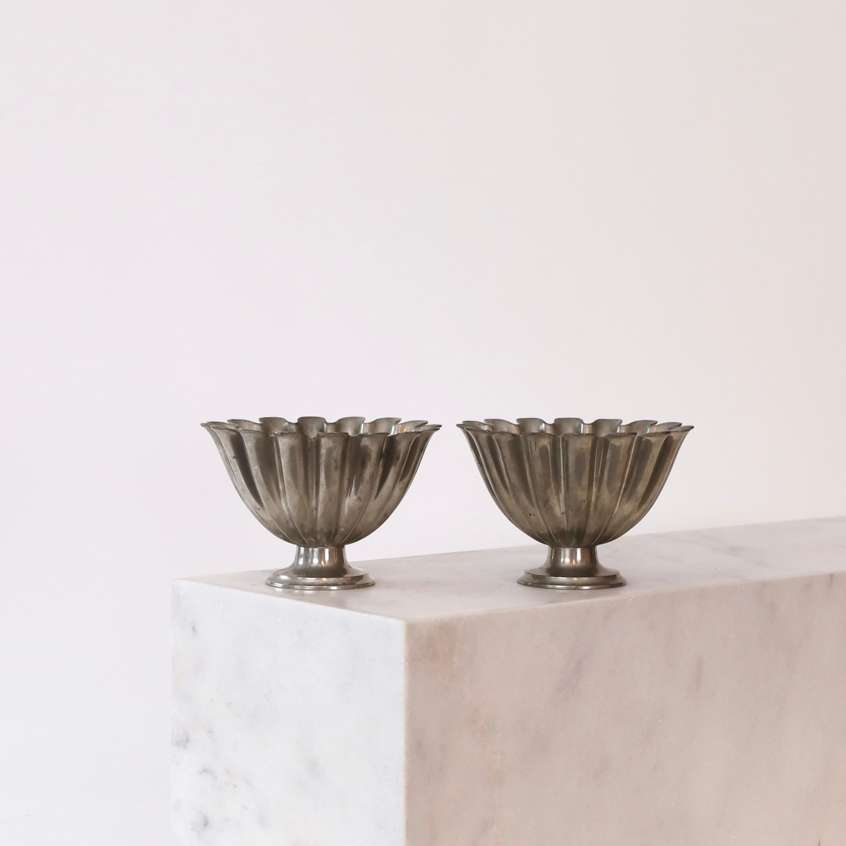 Pair of Scalloped pedestal pewter bowls designed by Just Andersen in the 1920s. A fine set for a beautiful home. 

* A pair (2) of round scalloped bowls on foot made in pewter 
* Designer: Just Andersen
* Model: 1228
* Year: 1918-1929
* Condition: