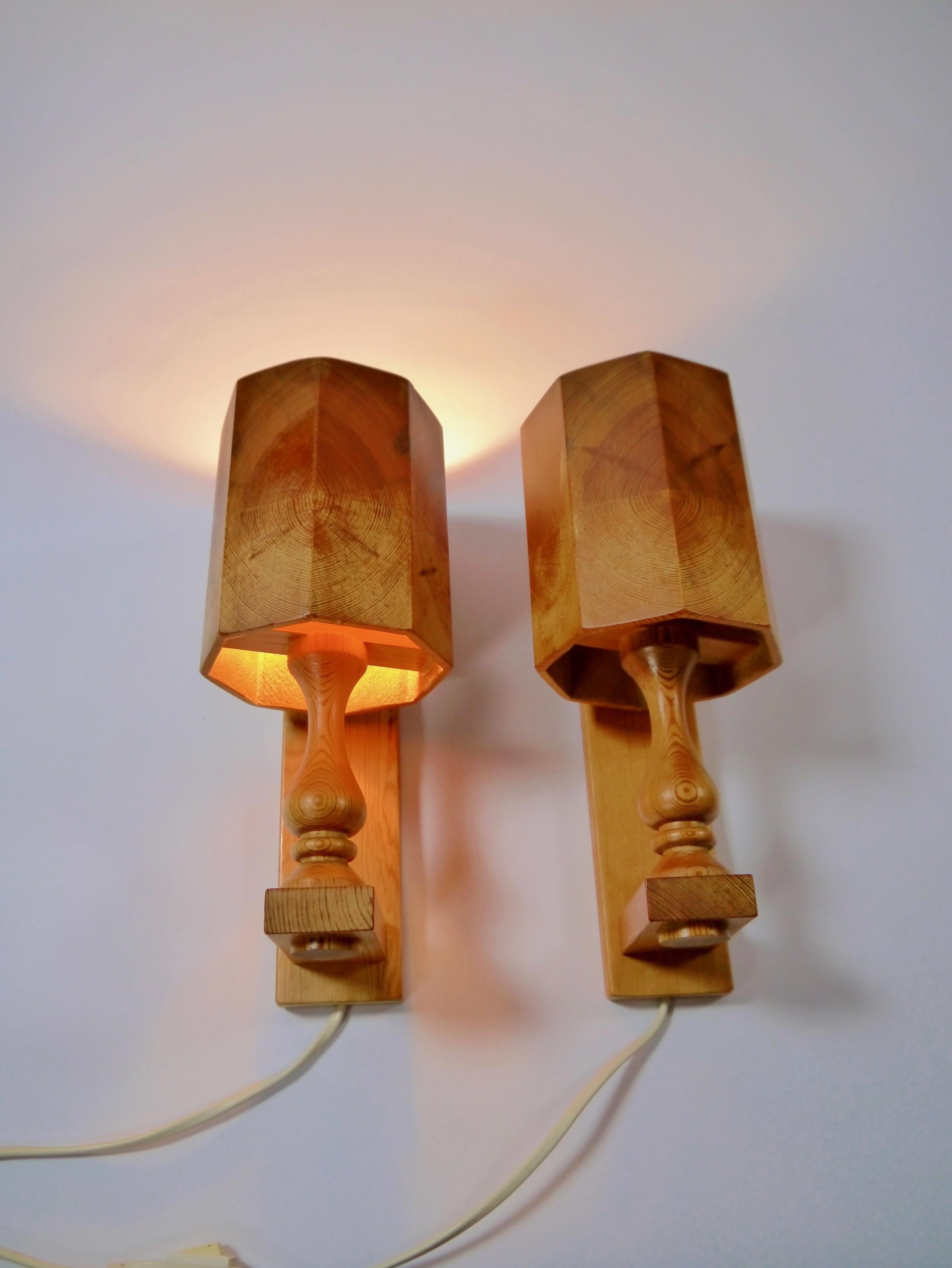 A pair of pinewood wall sconces fabricated in Sweden, 1970s. All solid pinewood, base and shade.