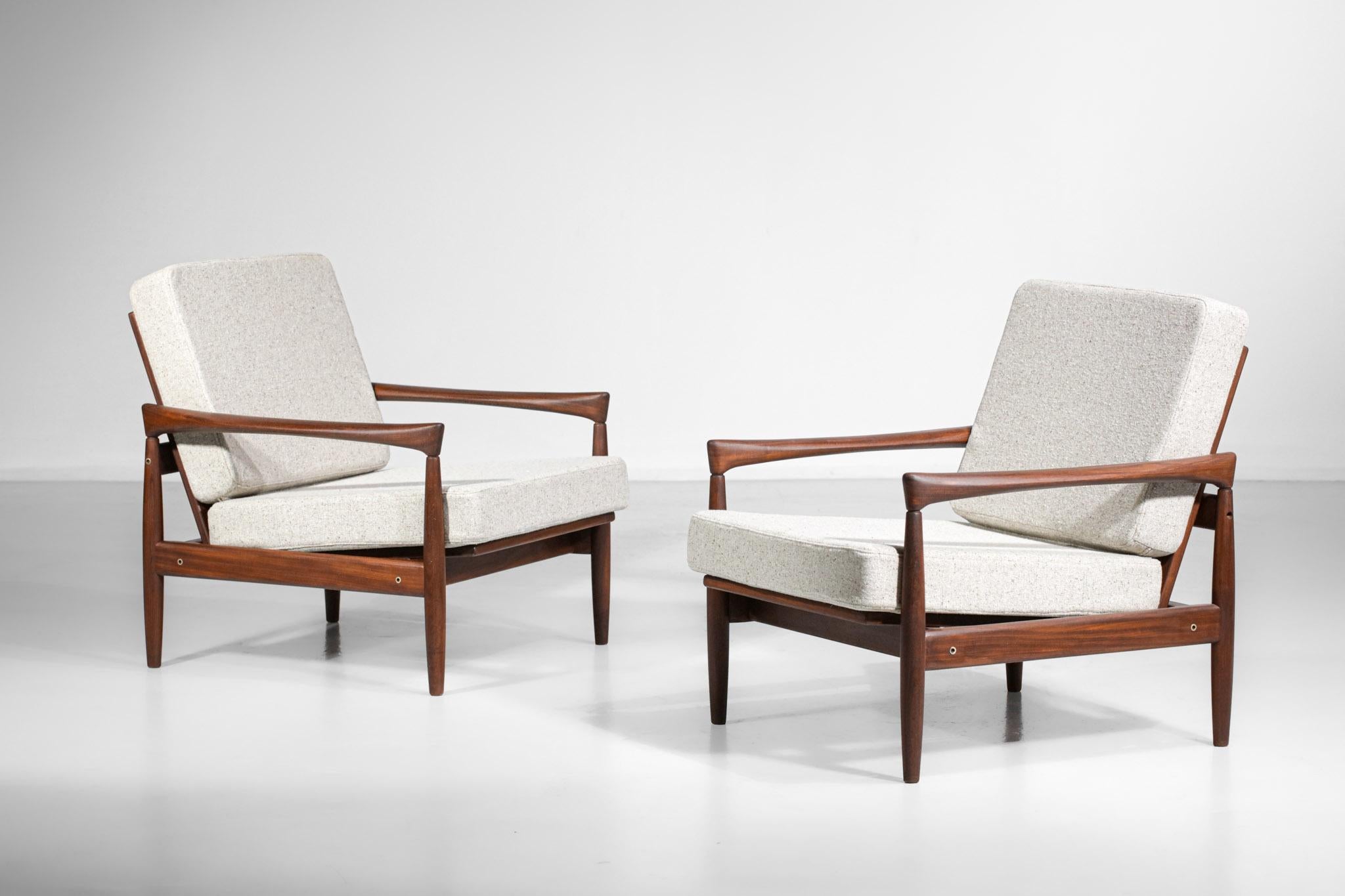 Nice pair of Scandinavian armchairs from the 60's by the Danish designer Erik Worts. Very nice vintage condition of the solid teak structures with typical Scandinavian furniture lines of the time. The seat covers have been refurbished in beige wool
