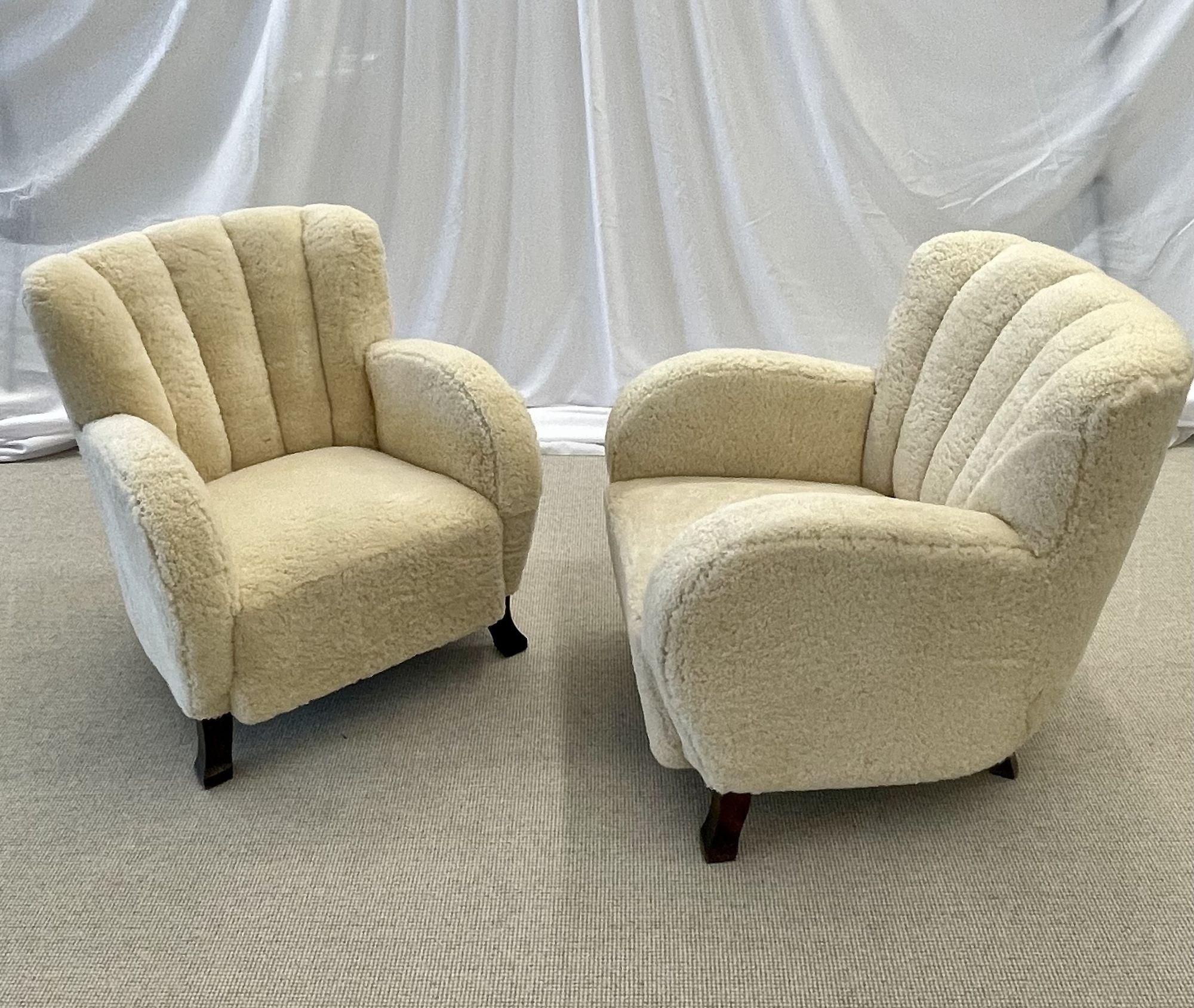 Swedish Mid-Century Modern, Art Deco Lounge Chairs, Beige Shearling, Wood, 1930s

Chic pair of Art Deco organic form lounge chairs designed and produced in Sweden circa 1930s. This stunning pair of Fritz Hansen style easy chairs feature a channeled