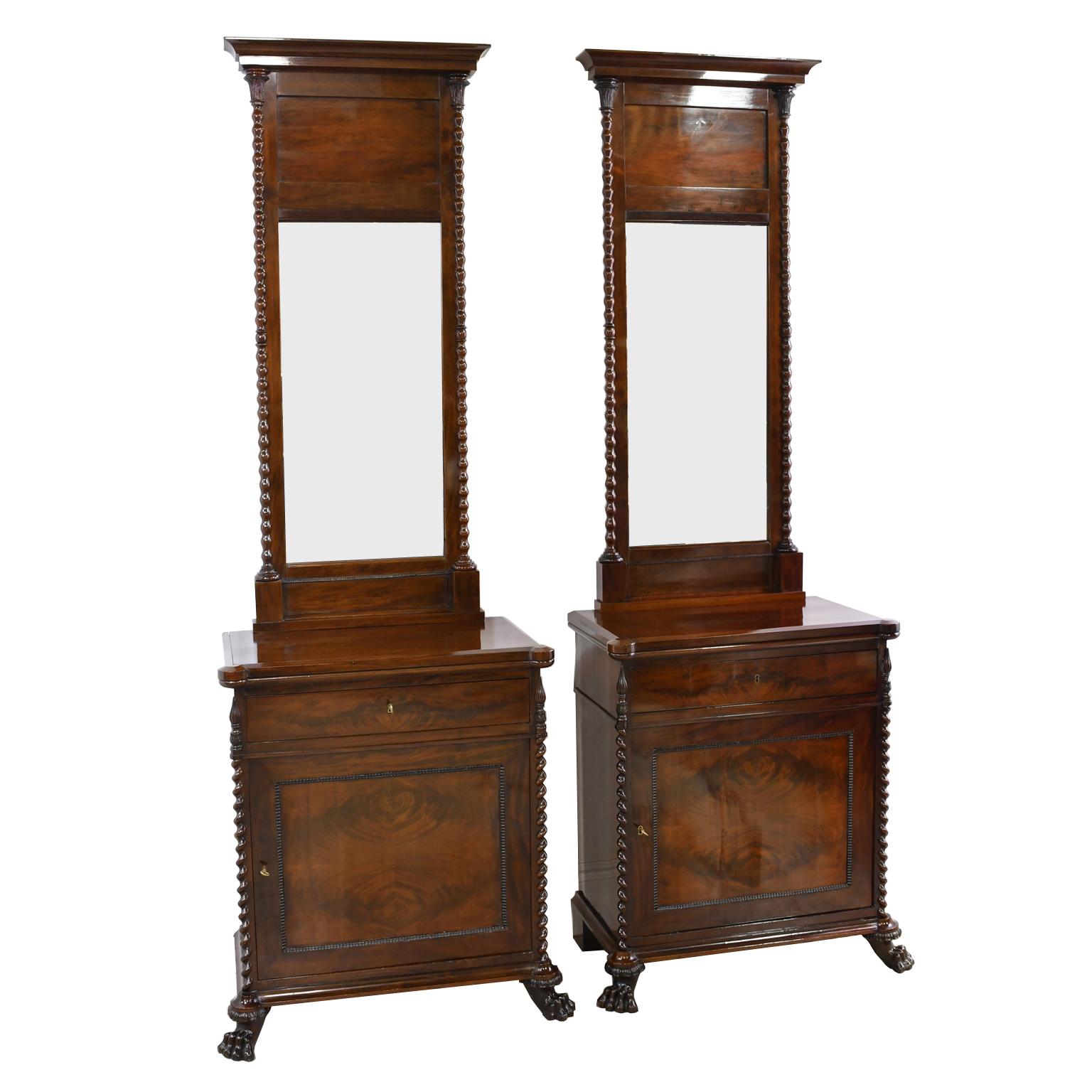 An exquisite pair of Scandinavian Biedermeier/ Empire console cabinets with matching mirrors in a dark, rich West Indies/ Cuban mahogany, Denmark, circa 1830. Sides of cabinets and mirrors are trimmed with twist turnings and capped with