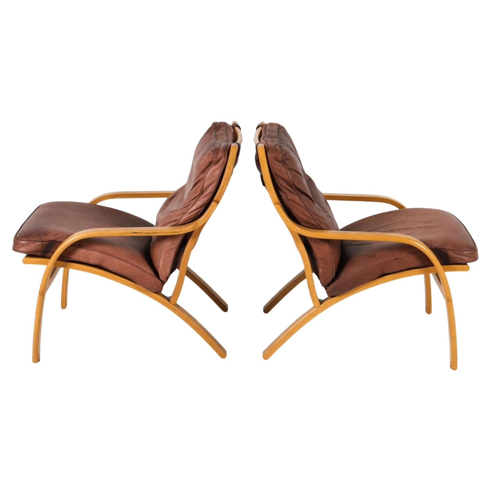 Pair of Scandinavian Brown Leather and Curved Beech wood lounge chairs Beech bentwood frames with cognac leather cushions. Leather shows signs of use and worn in nicely. Made in Denmark - Located in Brooklyn NYC.

Sold as a Pair of chair (2)

