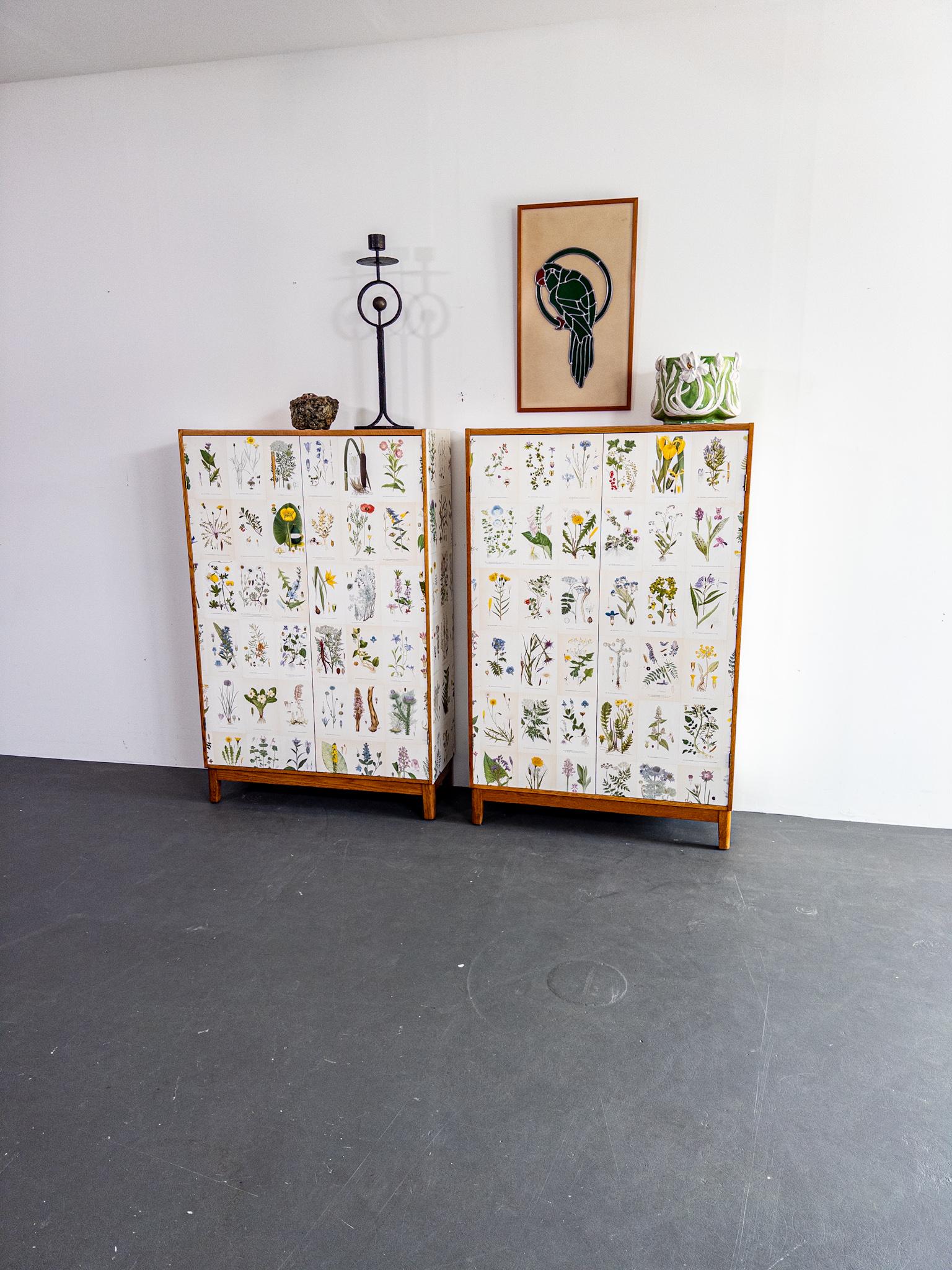 Une paire unique et captivante d'armoires scandinaves des années 1940, magnifiquement réimaginées avec un clin d'œil à l'art de Josef Frank. Ces armoires à cadre en chêne sont entièrement tapissées d'authentiques imprimés botaniques vintage de