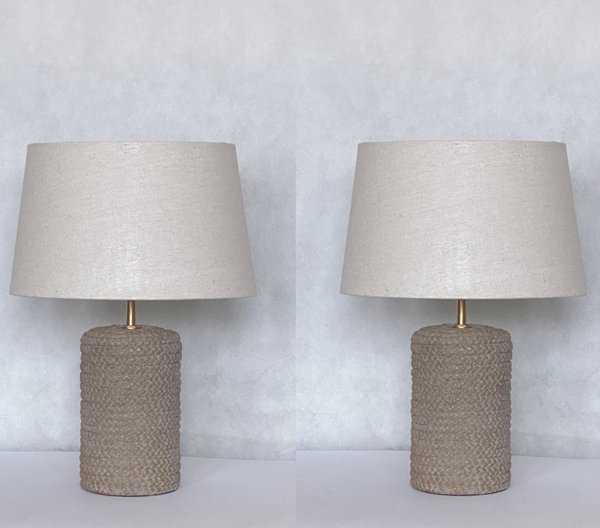 A beautiful pair of 1960s Scandinavian ceramic table lamps. Ceramic body in rope shape, with round linen shades. Both lamps in excelent condition, no damages, rewired, new shades. It takes one E27 large sized screw bulb up to 60W.
Measures: Height
