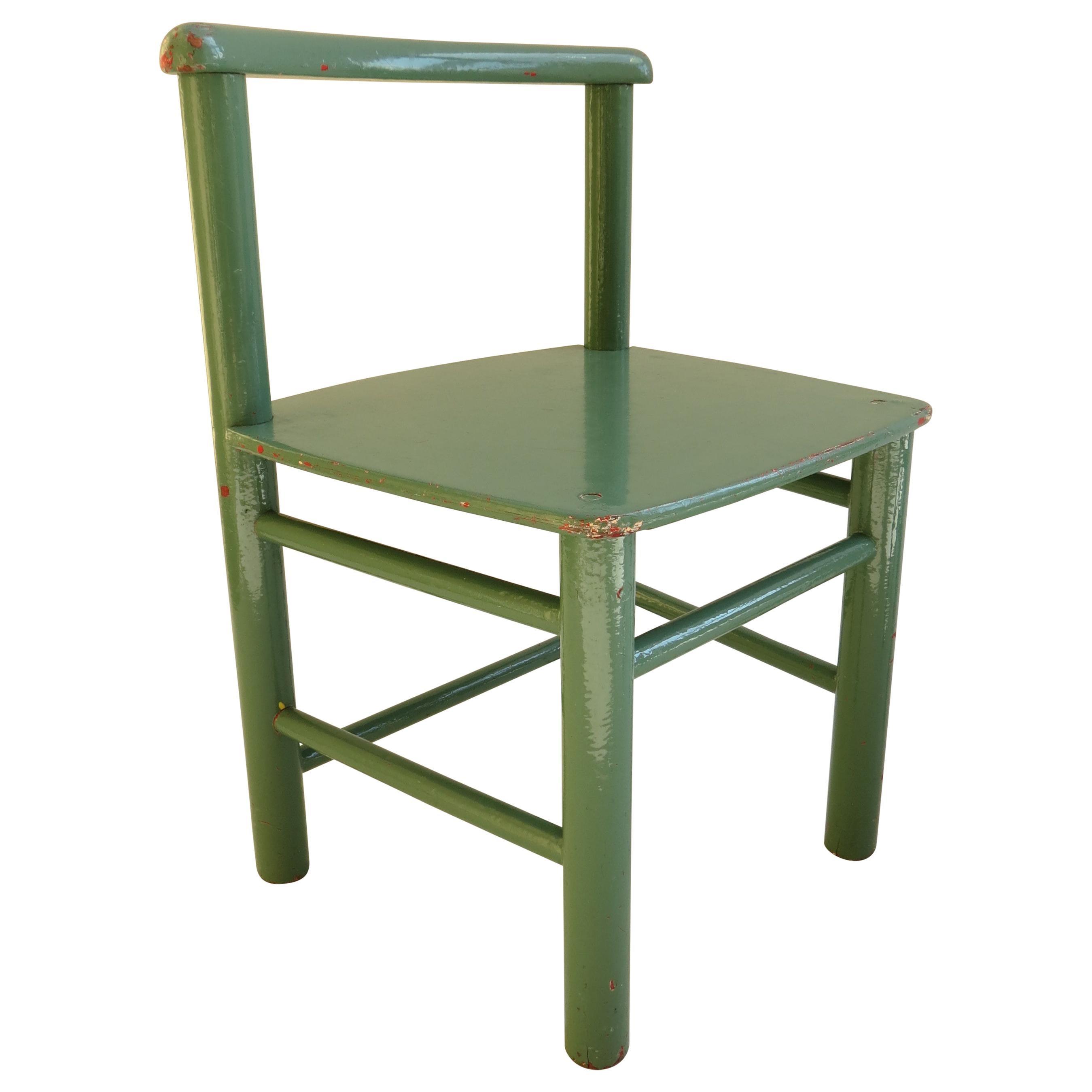 Pair of Scandinavian child’s chairs that date from the 1960s. Made from pine and plywood. They have both been overpainted, some time ago, they were originally red, then yellow and are now green. The paint is nicely distressed revealing the chairs’