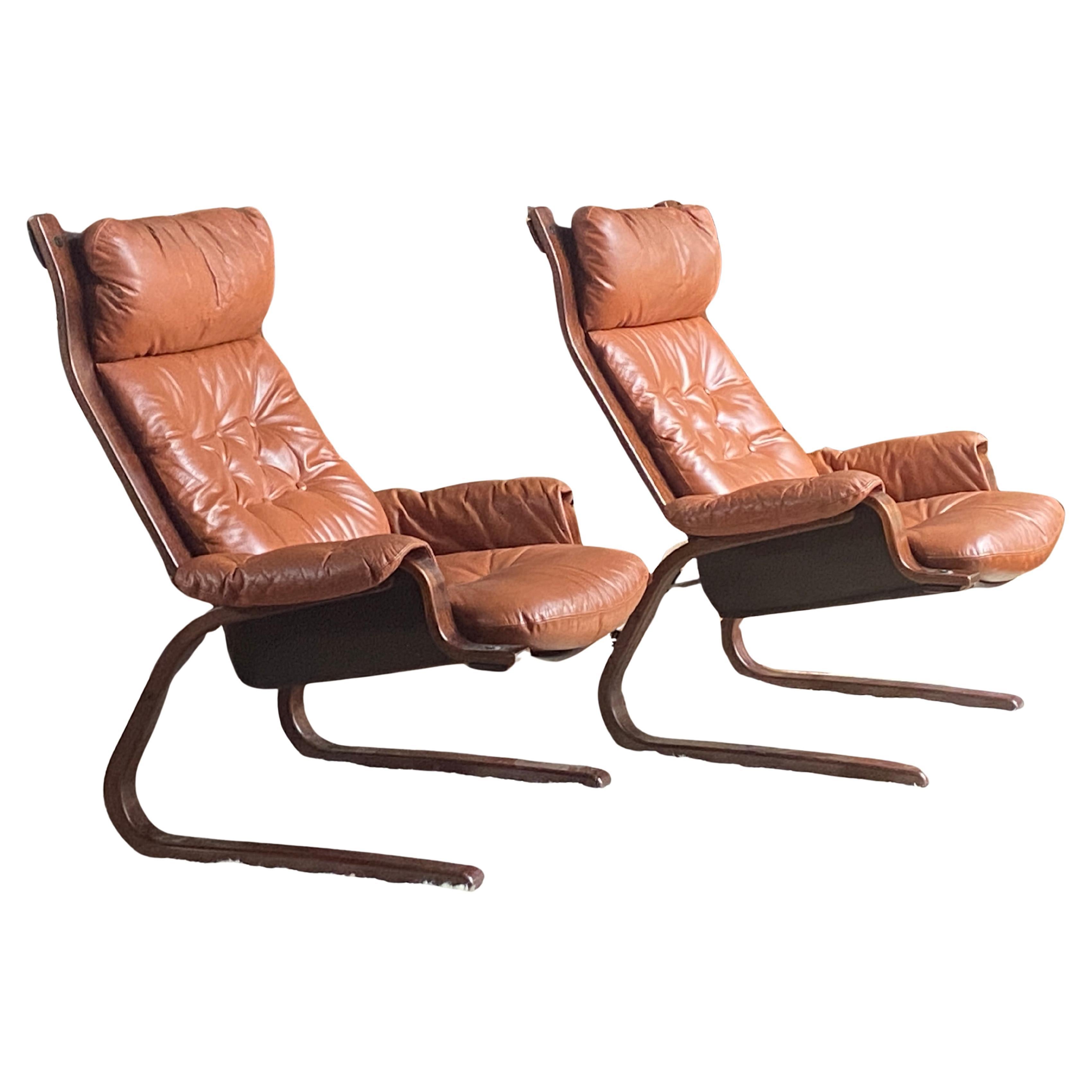 Pair of Scandinavian Einar Hove style cognac leather and bentwood lounge chairs