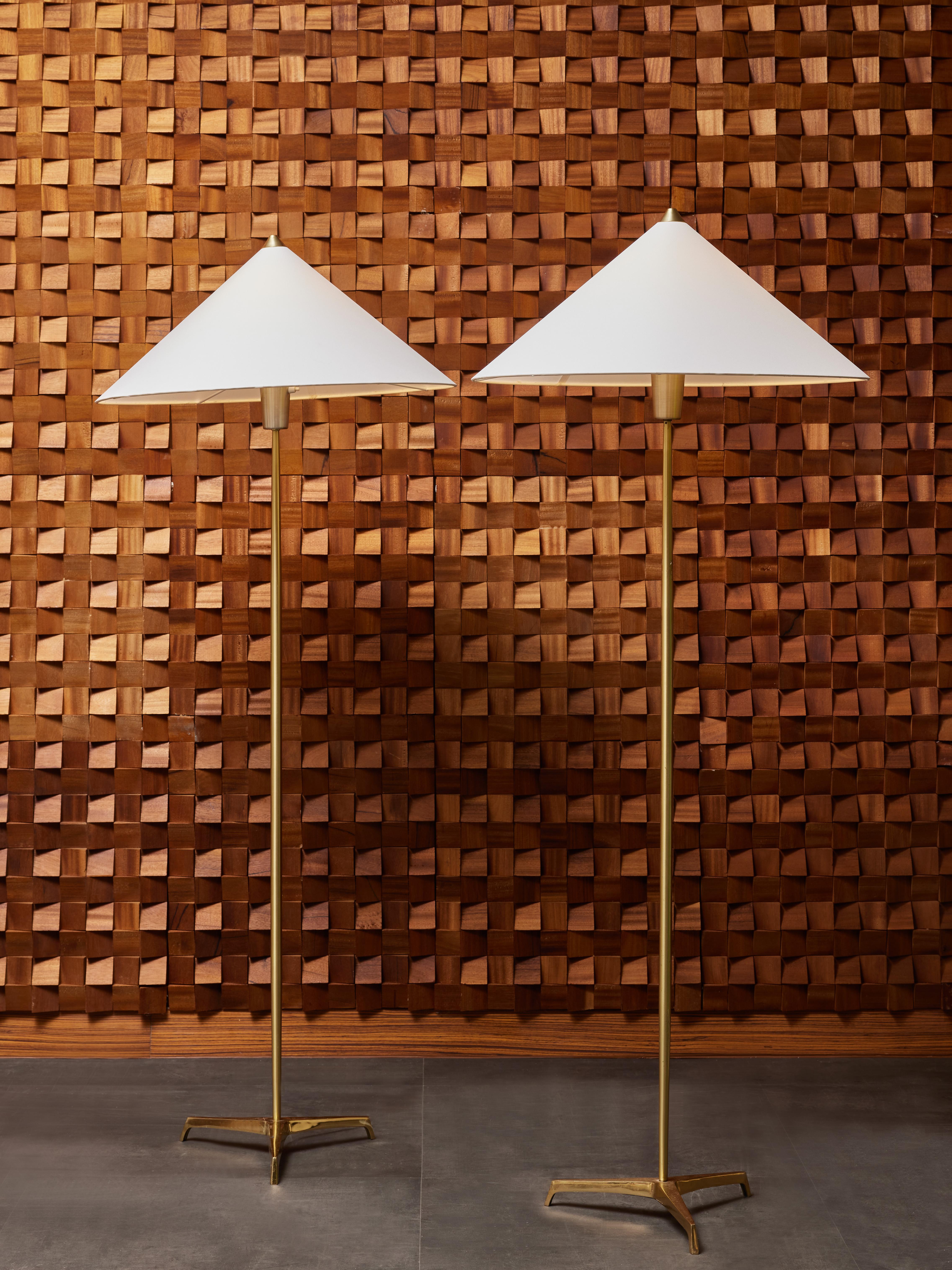 Pair of minimalist brass floor lamps topped with conical shades. Marked AHX 156 under the feet.