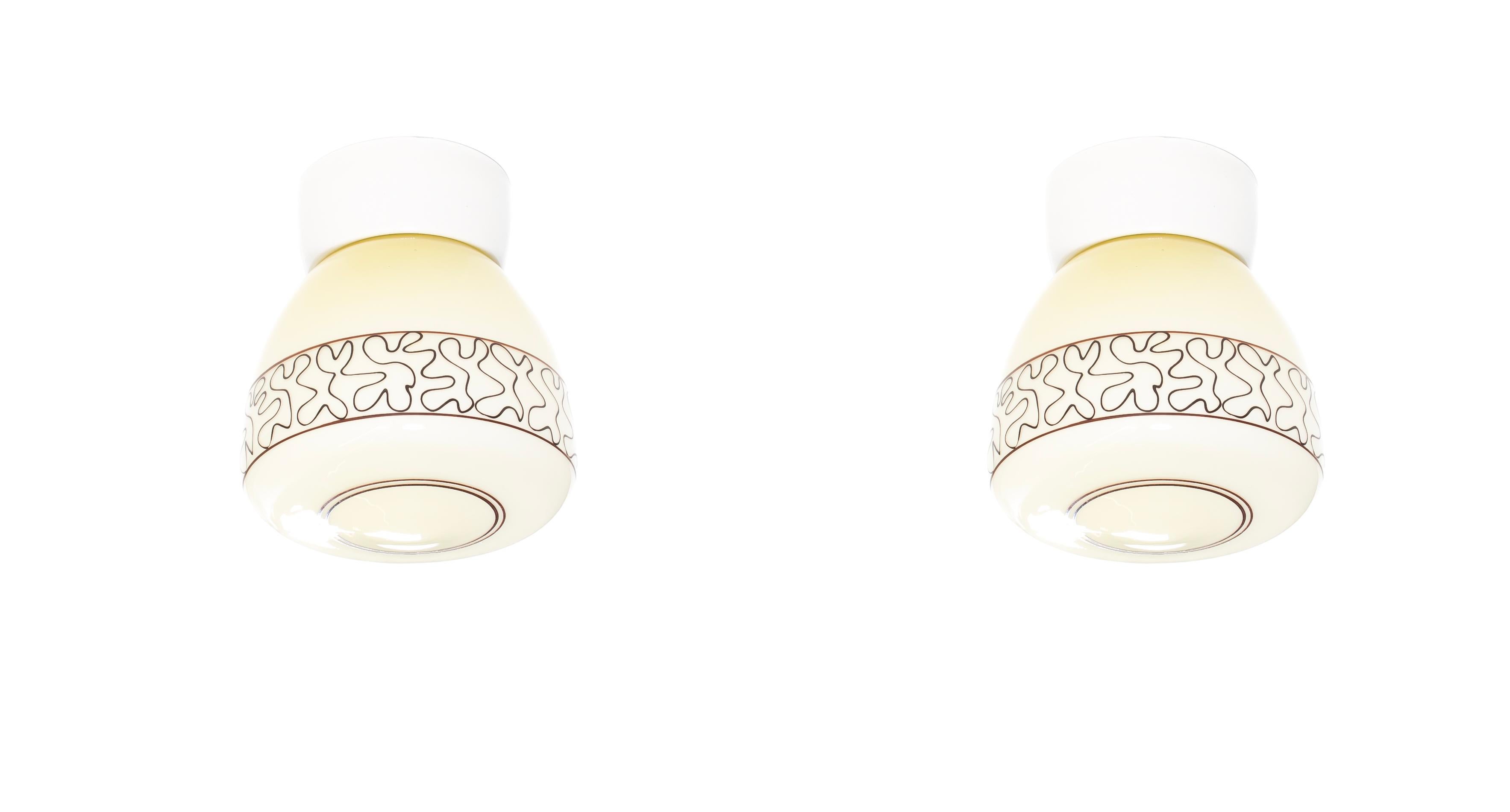 Wonderful pair of ceiling lights on a porcelain base with decorated shades in glass. Designed and made in Norway from circa 1950s first half by Høvik Lys. Both lamps are fully working and in good vintage condition. Each lamp utilizes one E27 bulb