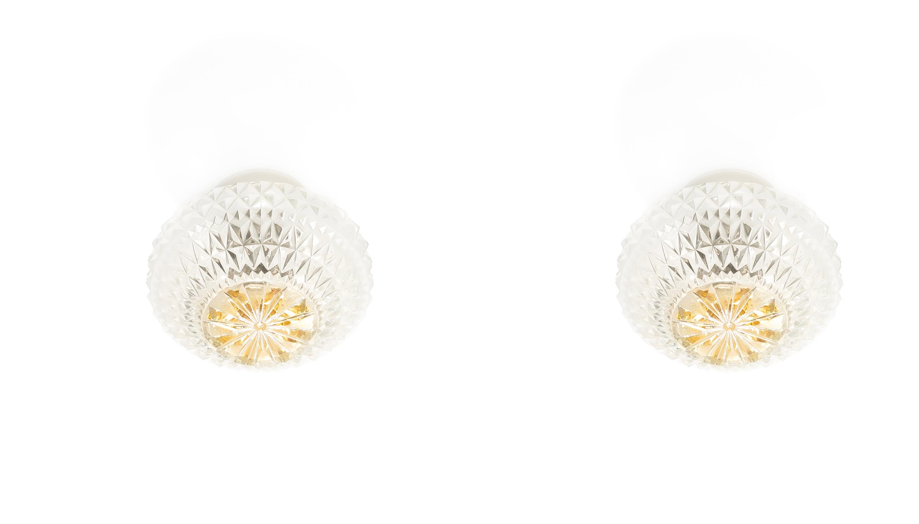 Wonderful pair of ceiling lights on a porcelain base with shades in crystalized glass. Designed and made in Norway from circa 1950s first half. Both lamps are fully working and in good vintage condition. Each lamp utilizes one E27 bulb and has a max