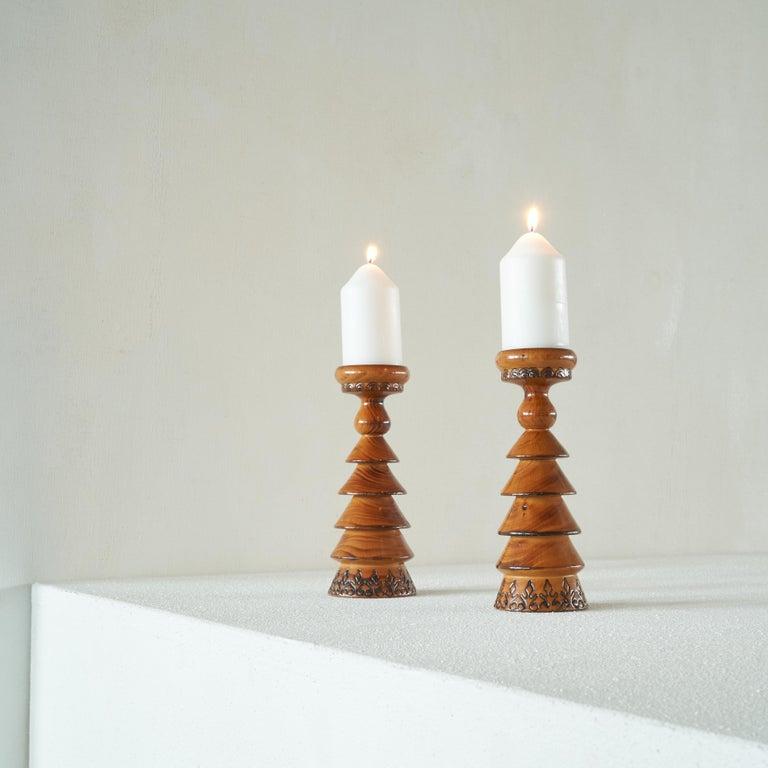 Pair of lacquered Scandinavian wooden candlesticks. Pine, mid 20th century.    A beautiful pair of remarkable and special candlesticks. Made of pine and lacquered in thick and glossy manner with a beautiful craquelÃ© viewed up close. The color and