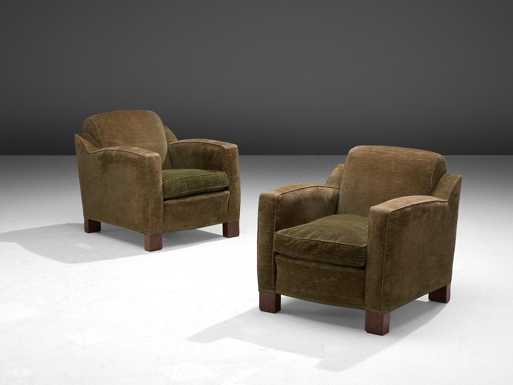 Pair of lounge chairs, green velours and wood, Scandinavia, 1940s

This pair of armchairs features parallelepiped. The set has a curvaceous feel and bulky, chunky aesthetic. The pieces are functional, rational and modest. The seat is finished with