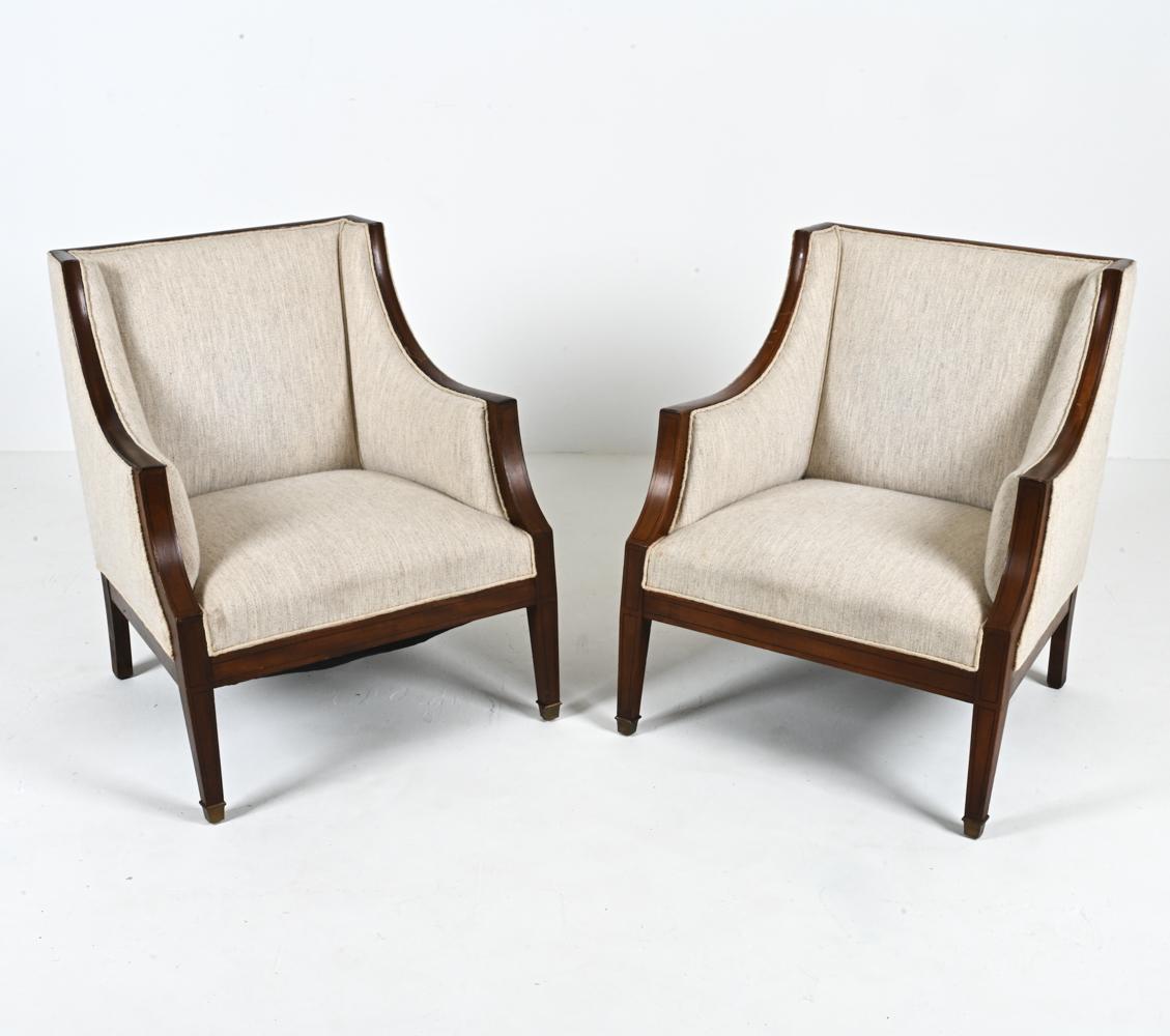 Bring serene comfort to your home with this stately pair of armchairs, crafted by a master Scandinavian furnituremaker in the style of Frits Henningsen. The unique silhouette features a square back with cozy sloped shelter-style arms, all delineated