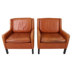 Pair of Scandinavian Mid Century modern Cognac Leather Low Lounge chairs