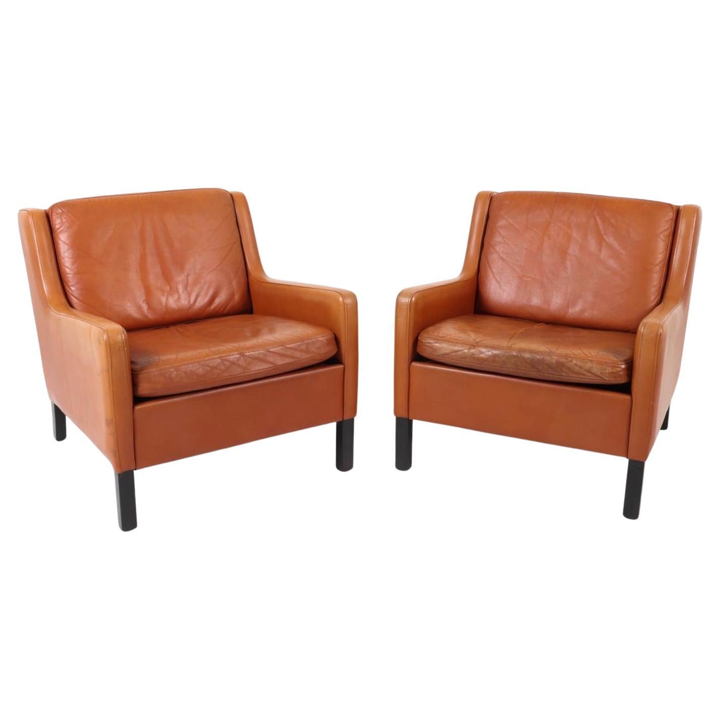 Pair of Scandinavian Mid Century modern Cognac Leather Low Lounge chairs