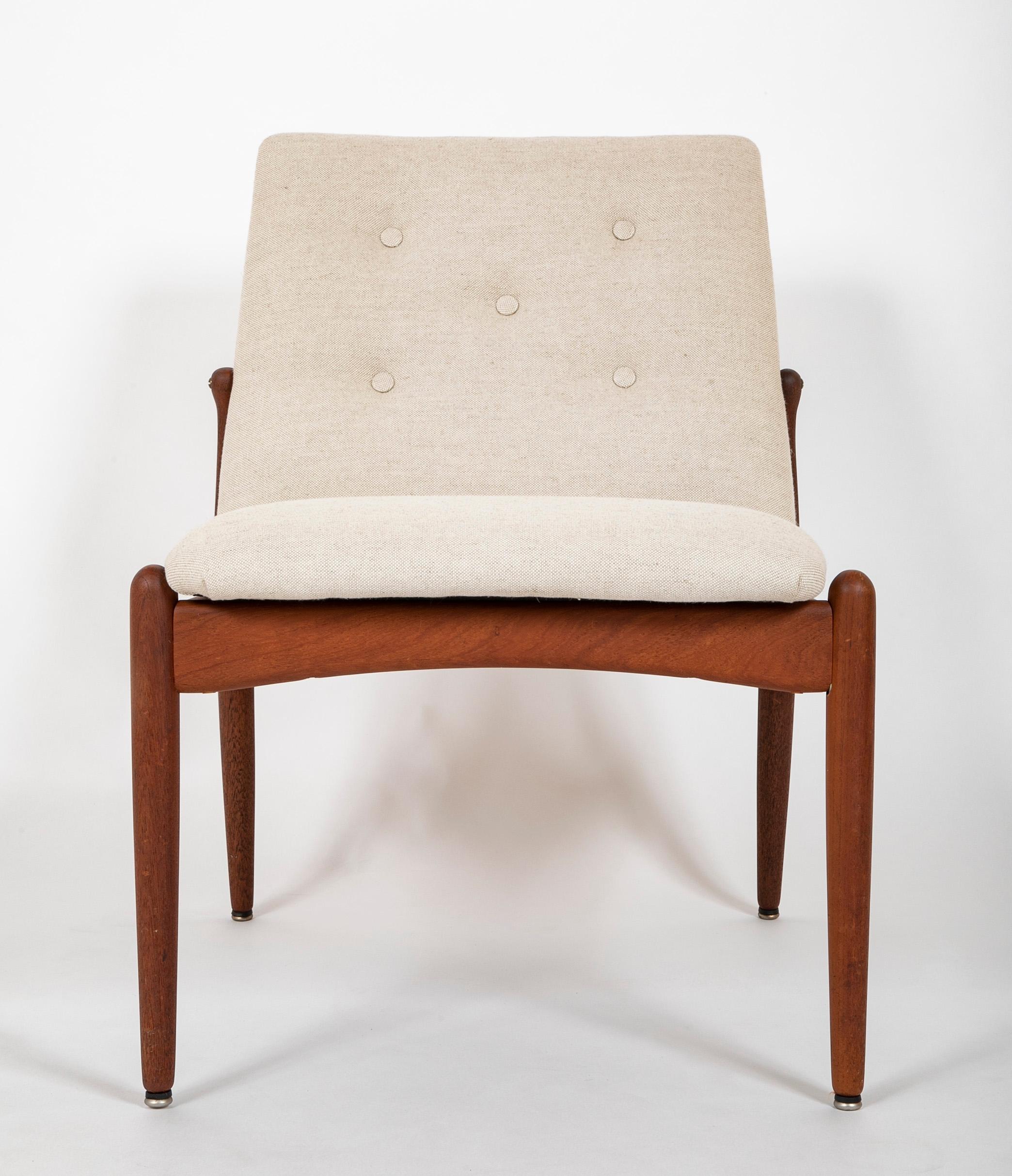 A pair of Scandinavian Mid-Century Modern teak slipper chairs.  Circa 1960's.