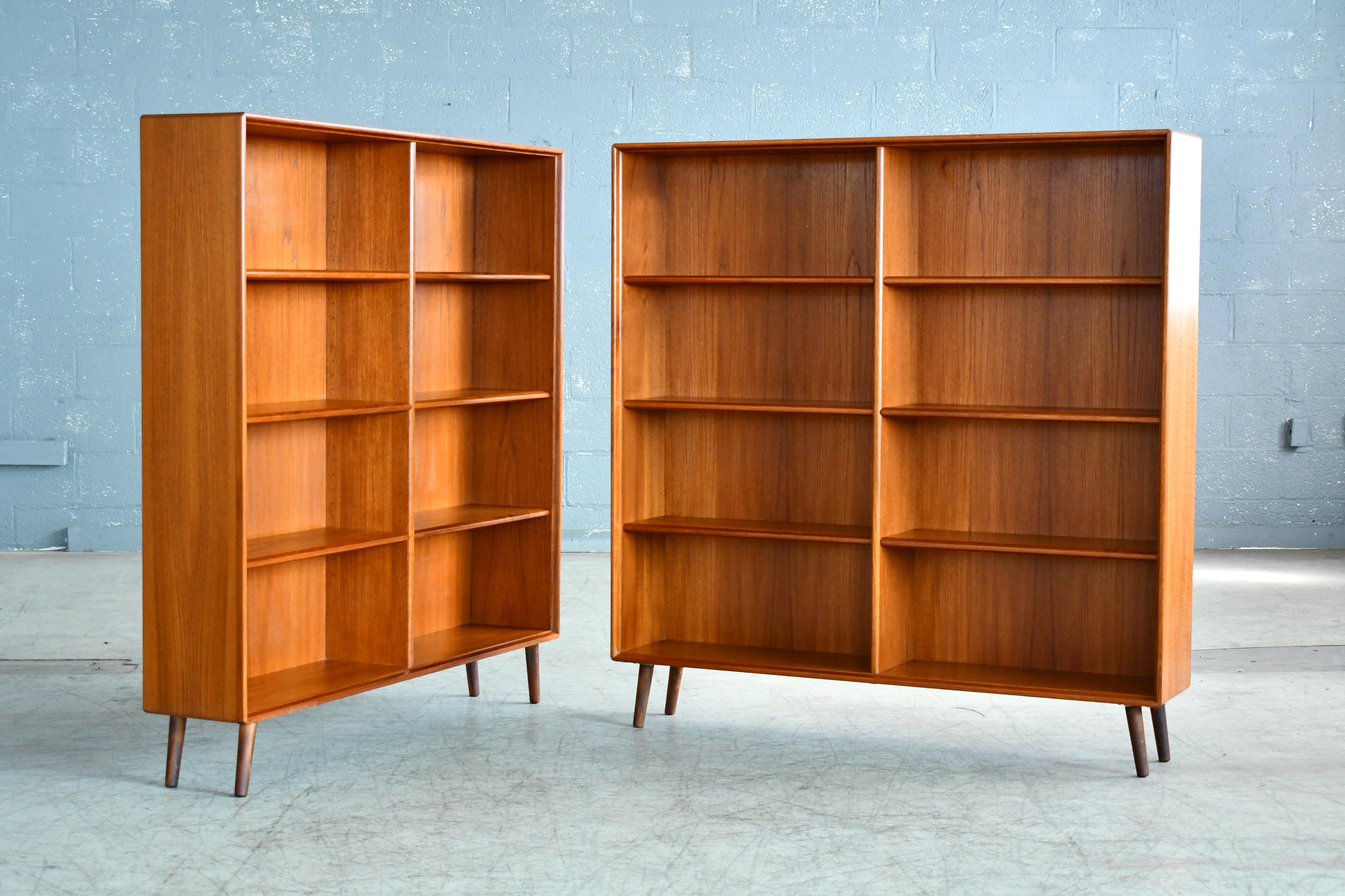 Pair of Scandinavian bookcases in teak designed by Bertil Fridhagen for Bodafors of Sweden manufactures sometime in the late 1960s. Both bookcases marked with the makers logo. Very high end construction with beautiful grain and color. Shelves all