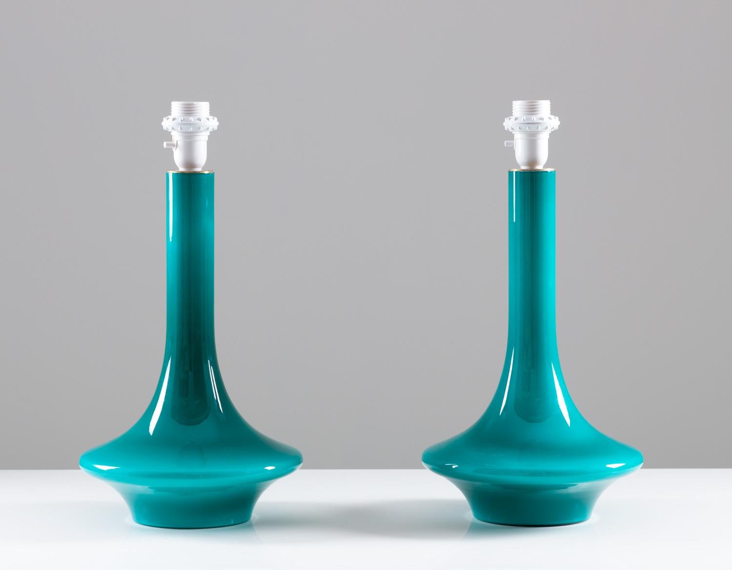 Set of two table lamps, probably manufactured by Luxus, Sweden, 1960s.
The lamps are made of glass with brass details. The design is simple and elegant with the slim waist and deep turquoise color.
Condition: Excellent vintage condition
Measures: