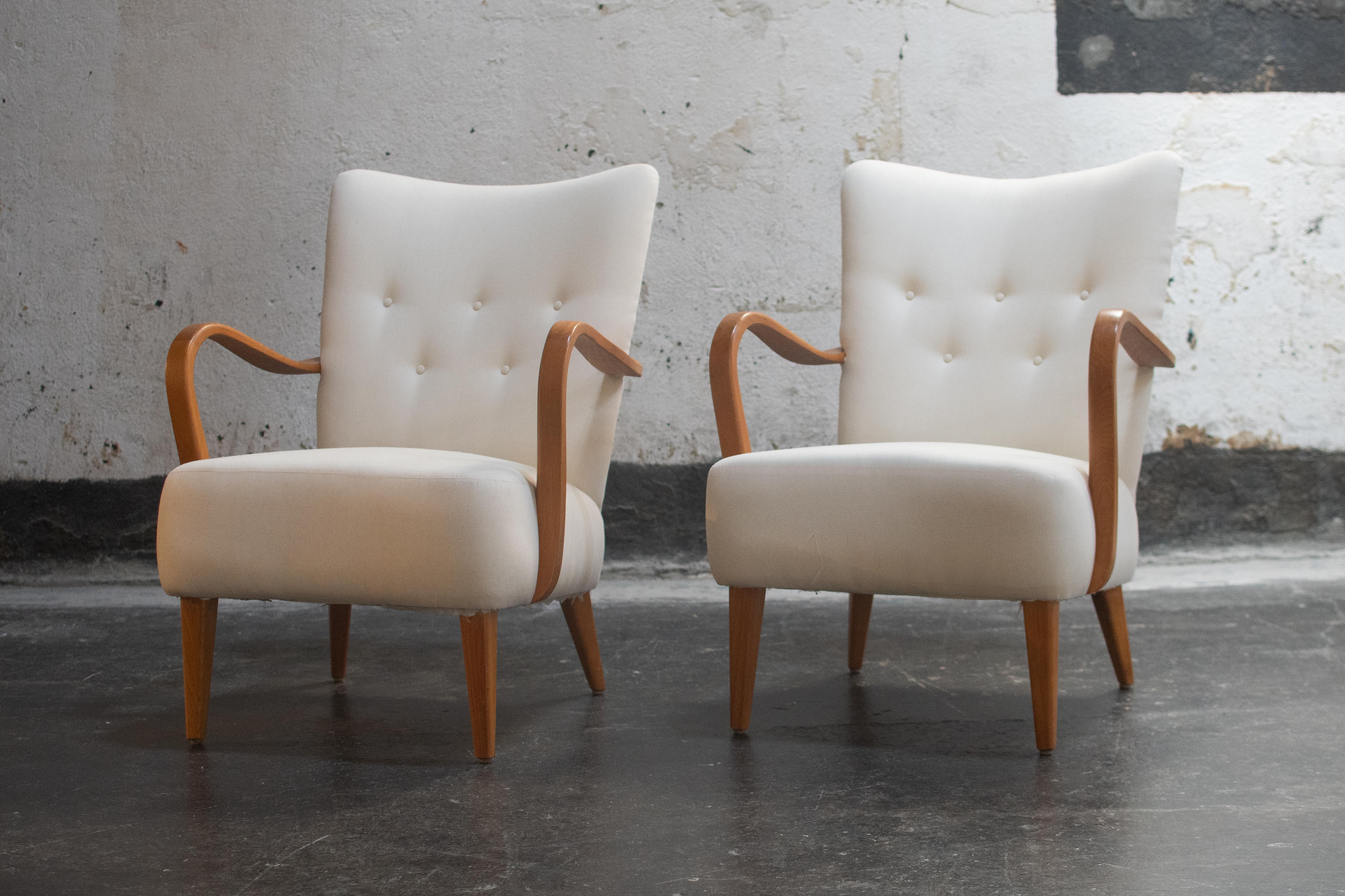 This pair of Scandinavian Modern bentwood birch arm chairs have been fully restored and are ready to be reupholstered. Scandinavian interiors often have very low ceilings to contain heat, seating tends to be diminutive in footprint  but is