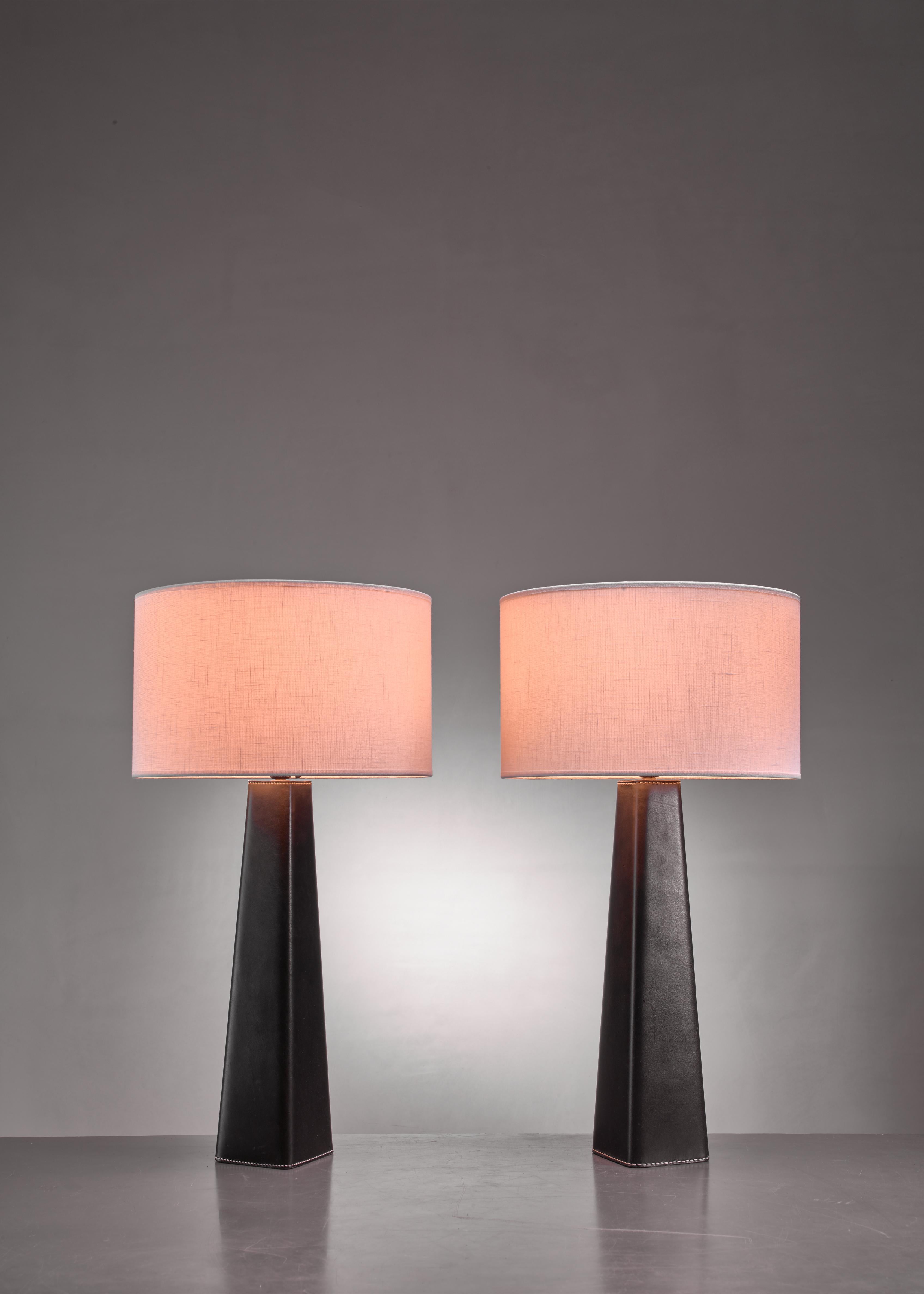 A pair of Scandinavian Modern conical table lamps with a stem wrapped in black, stitched leather.

The measurements and prices stated are of the lamps without a shade.
The shades are newly made and other dimensions and colors are available upon